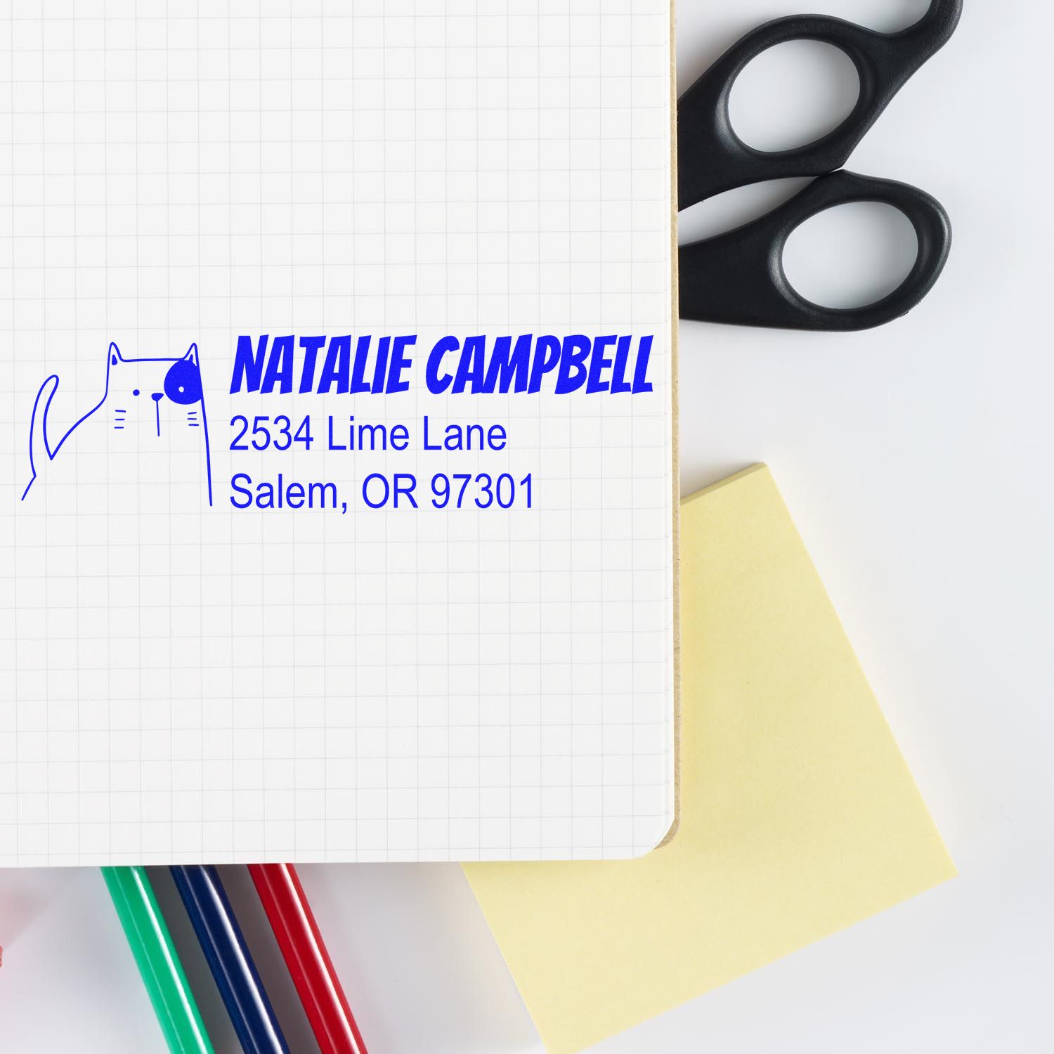 Personalized cat return address rubber stamp with name and Salem, OR address on notebook, ideal for custom mailing labels.