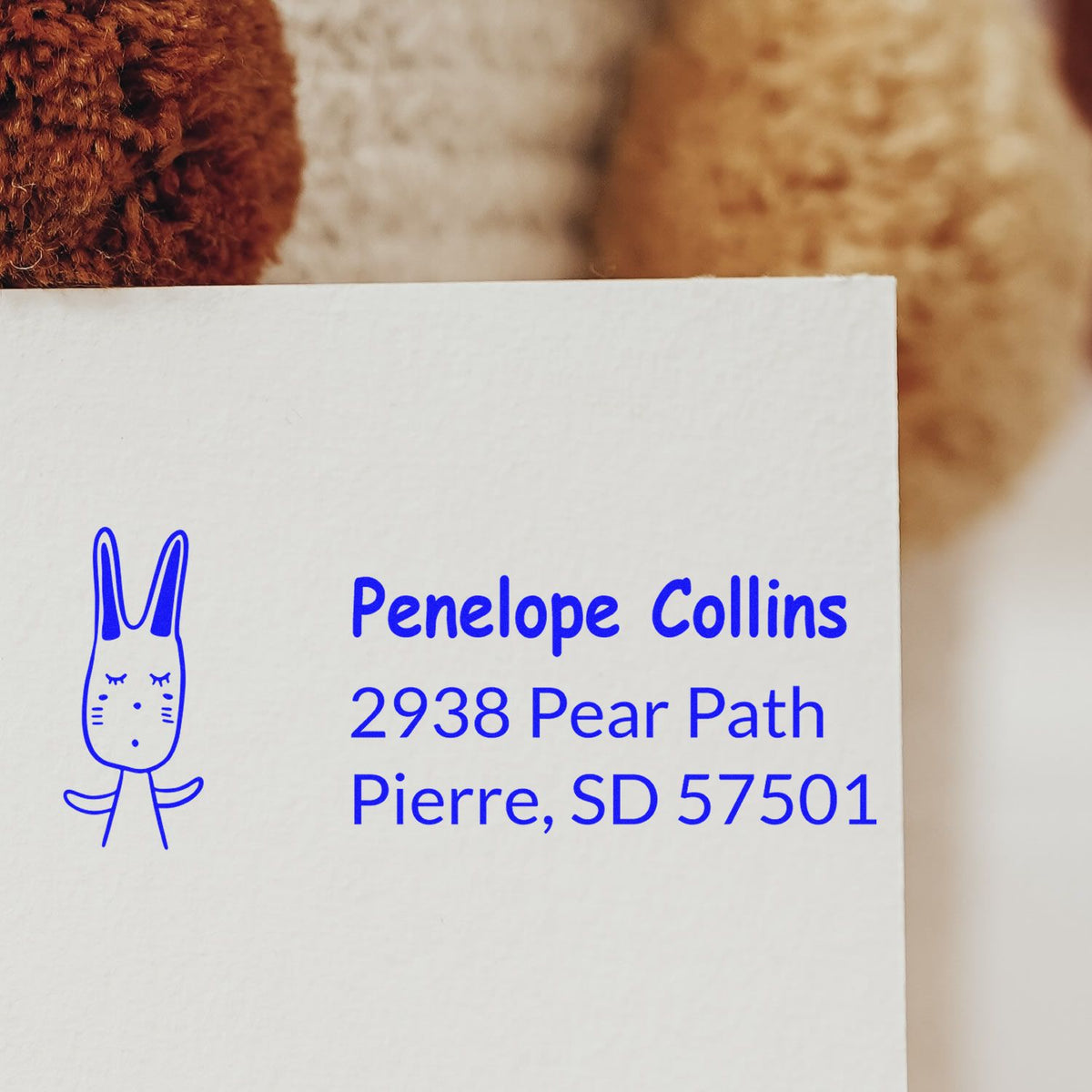 Custom rubber address stamp with bunny icon for Penelope Collins, 2938 Pear Path, Pierre, SD 57501.