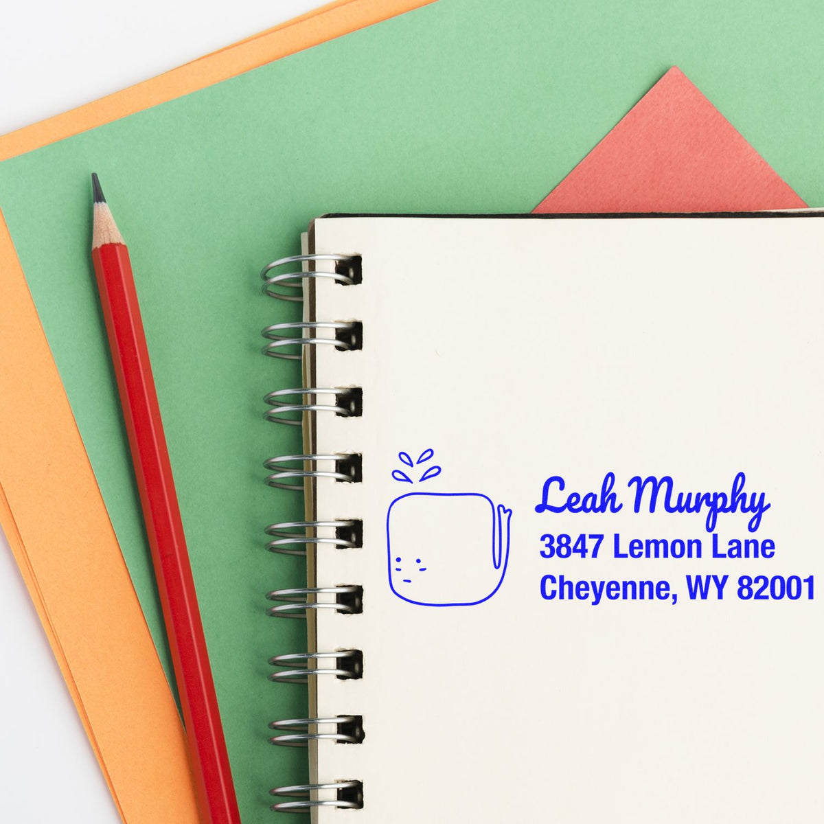 Custom return address rubber stamp on notebook for personalized stationery, featuring Leah Murphy, Cheyenne, WY.