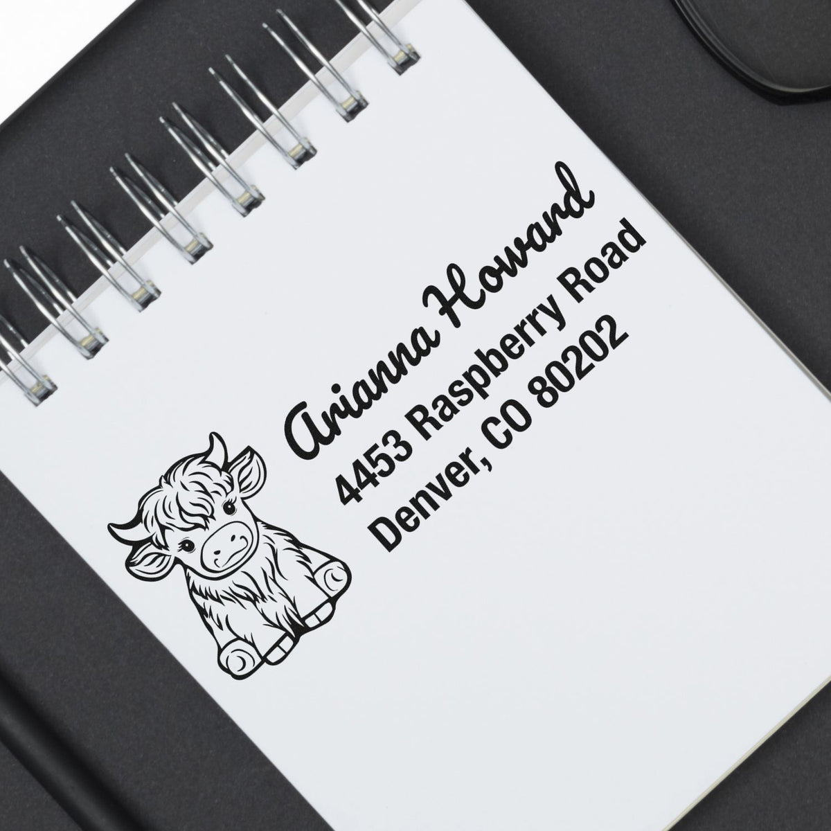 Personalized return address rubber stamp with cow illustration for Arianna Howard, Denver, CO 80202.