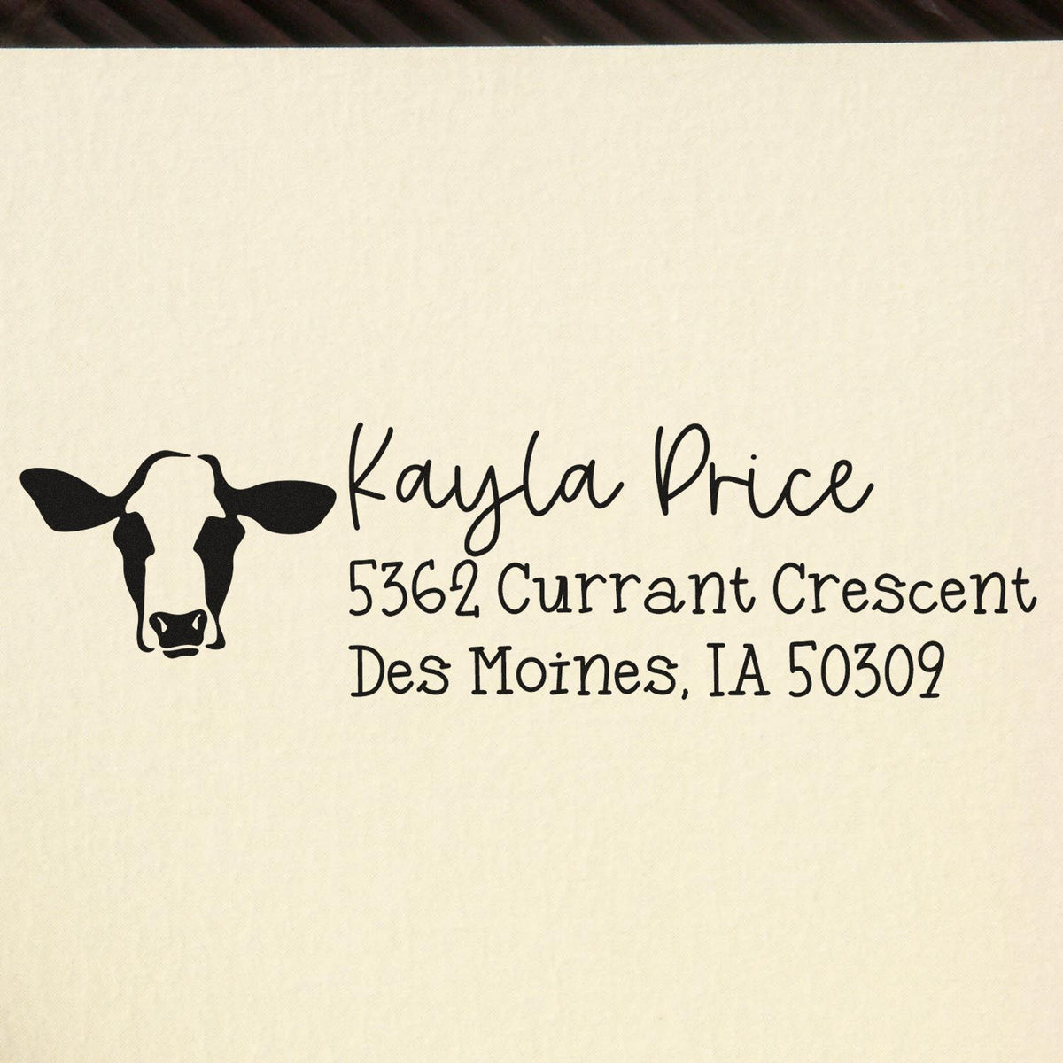 Custom cow return address rubber stamp with Kayla Price name and Des Moines, IA address
