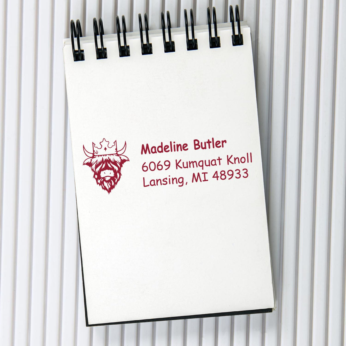 Personalized return address rubber stamp with bull logo for Madeline Butler, Lansing, MI