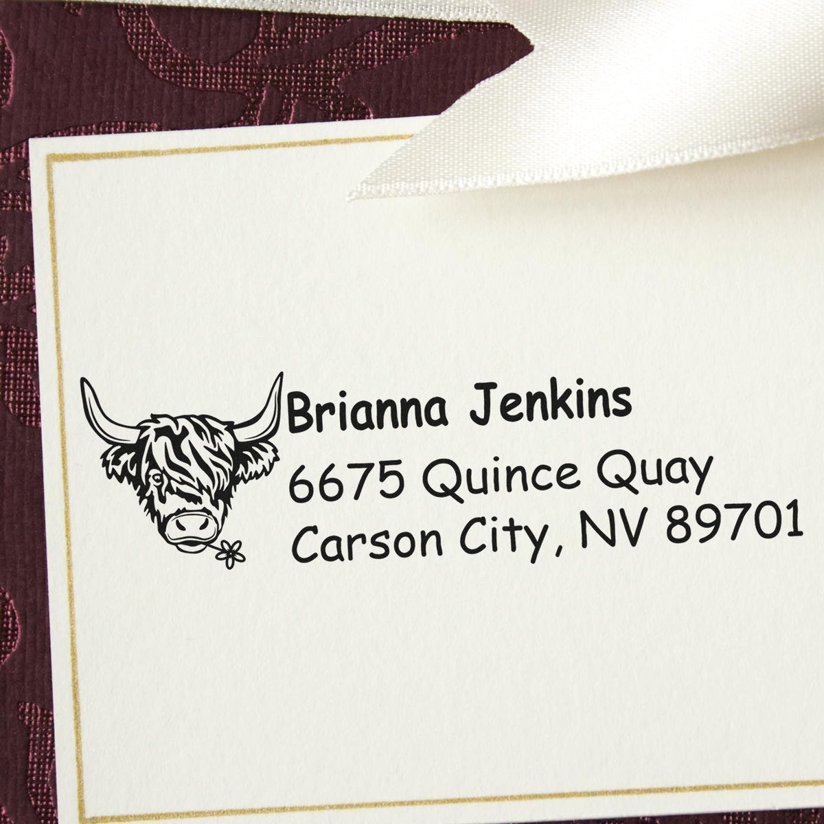 Custom rubber address stamp with cow logo, featuring Brianna Jenkins, 6675 Quince Quay, Carson City, NV 89701.