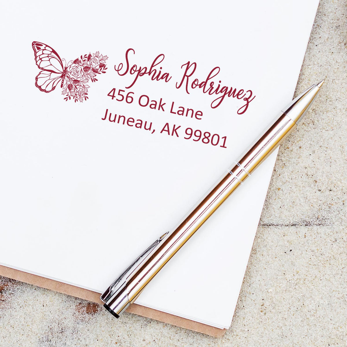 Custom butterfly floral return address rubber stamp for Sophia Rodriguez, Juneau, AK 99801.