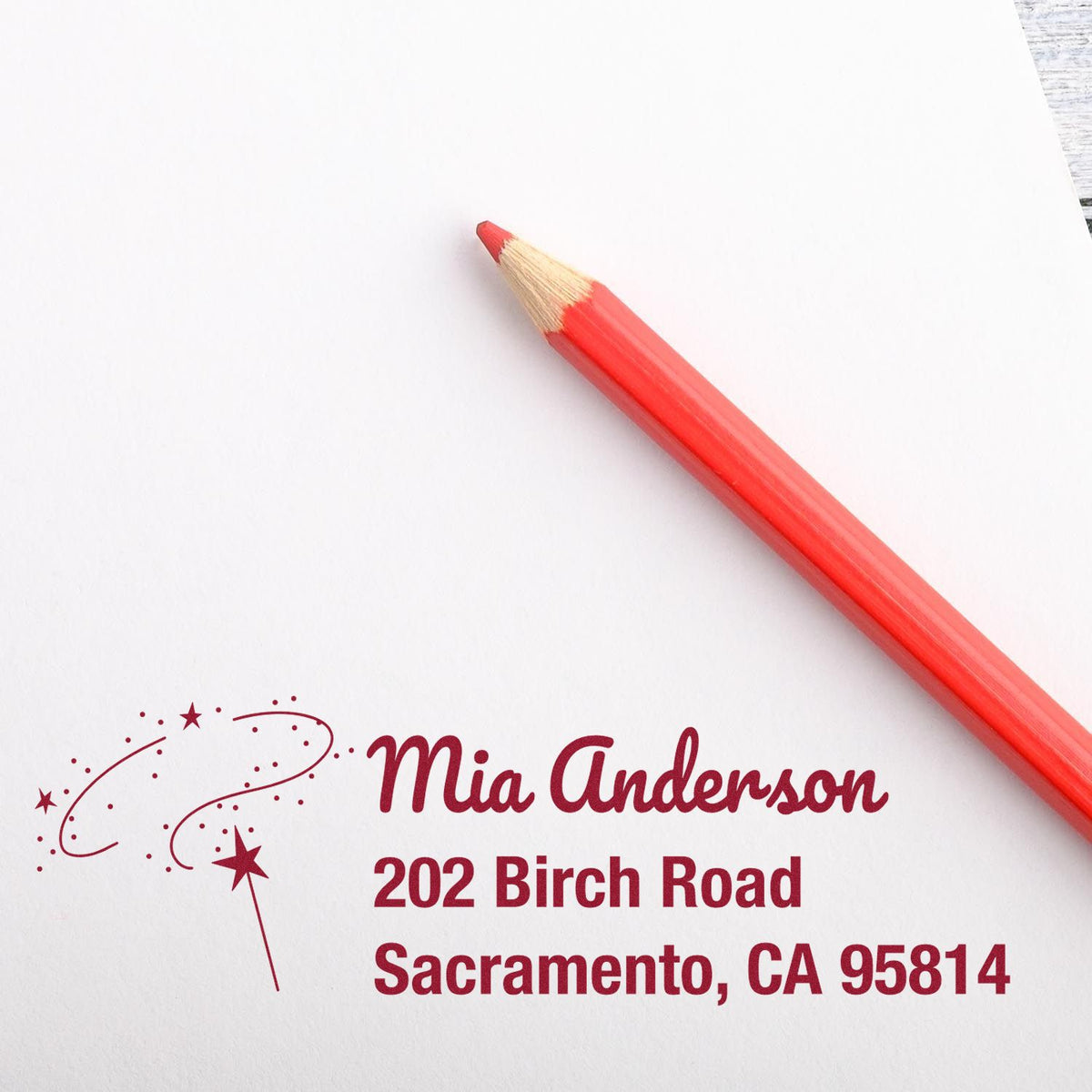 Personalized return address rubber stamp with decorative stars and name, for custom stationery and mailing labels.
