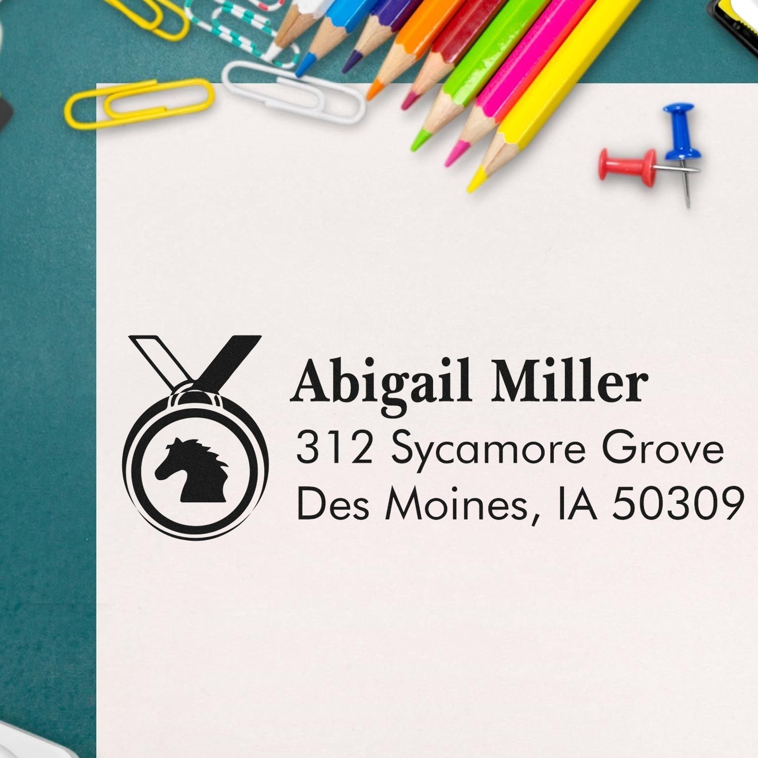Personalized return address rubber stamp with horse logo for Abigail Miller, 312 Sycamore Grove, Des Moines, IA 50309.