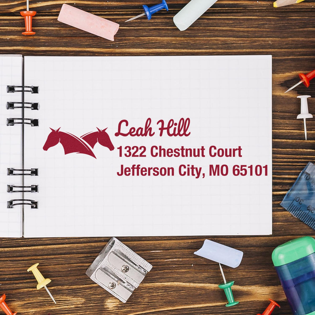 Custom horse return address rubber stamp impression with name and Jefferson City, MO address on a notebook page.
