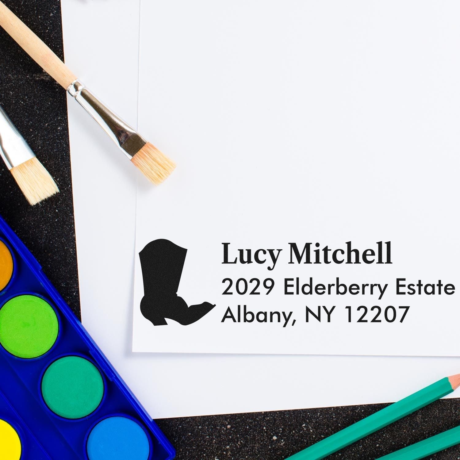 Custom rubber stamp return address for Lucy Mitchell, Albany NY 12207, ideal for wedding and event invitations.
