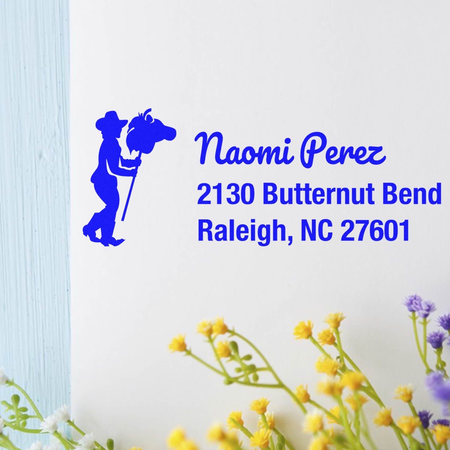Custom return address rubber stamp with farm silhouette for Naomi Perez, 2130 Butternut Bend, Raleigh, NC 27601.