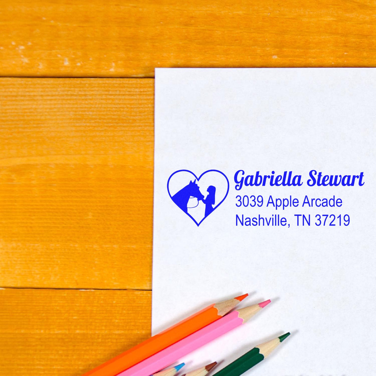 Custom rubber address stamp with heart horse logo, Gabriella Stewart name, and Nashville, TN return address on white paper.