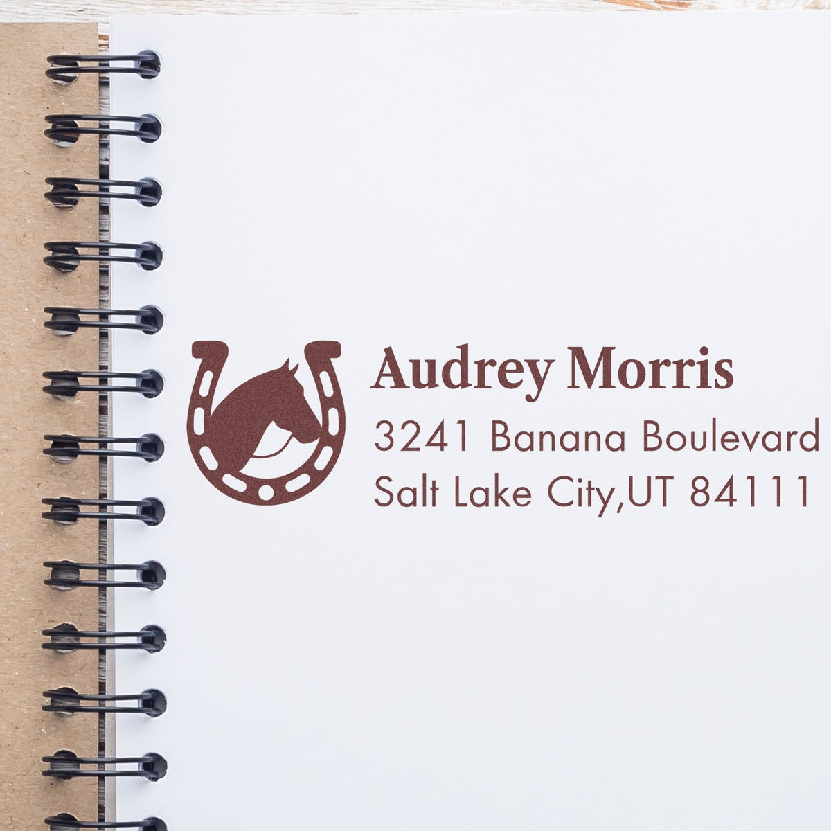 Custom horse logo return address rubber stamp for Audrey Morris, Salt Lake City, UT, shown on a notebook page.