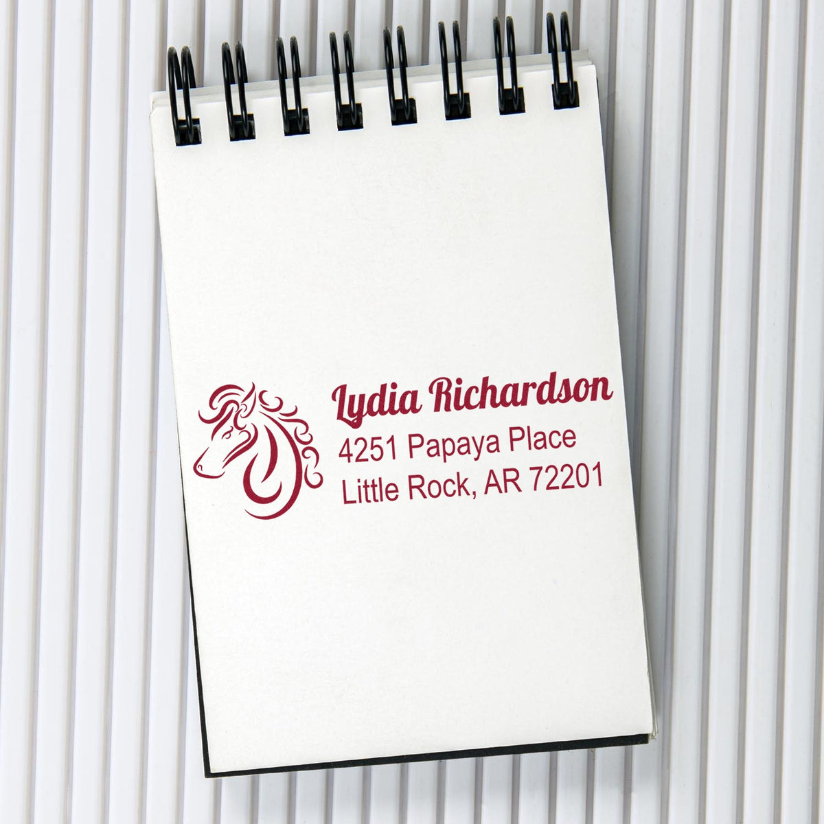Custom horse logo address rubber stamp impression on notebook paper