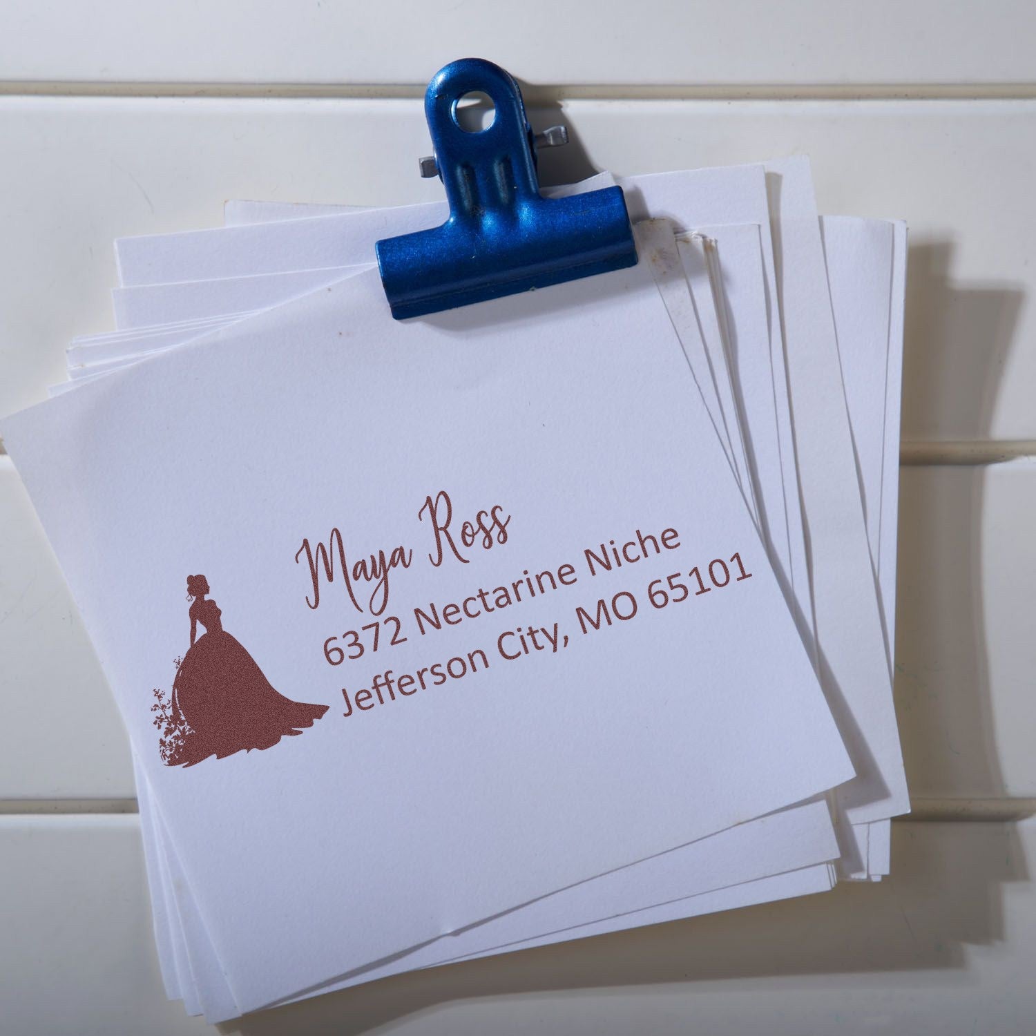 Custom return address rubber stamp on stationery, featuring a bride silhouette and personalized name and Missouri address.