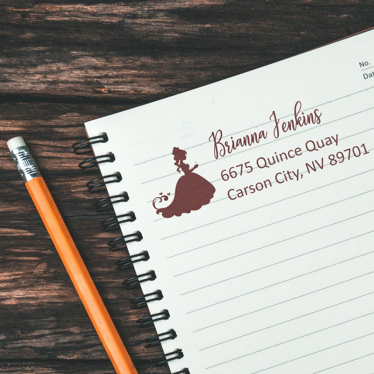 Custom address rubber stamp with princess silhouette on notebook, ideal for personalized stationery and wedding invitations.