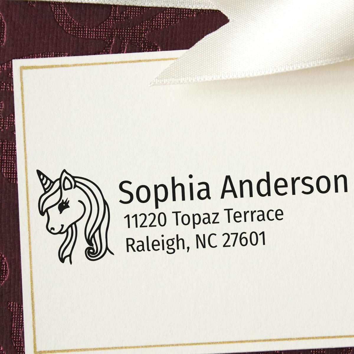 Custom unicorn rubber address stamp for Sophia Anderson, featuring name and Raleigh, NC address on personalized stationery.