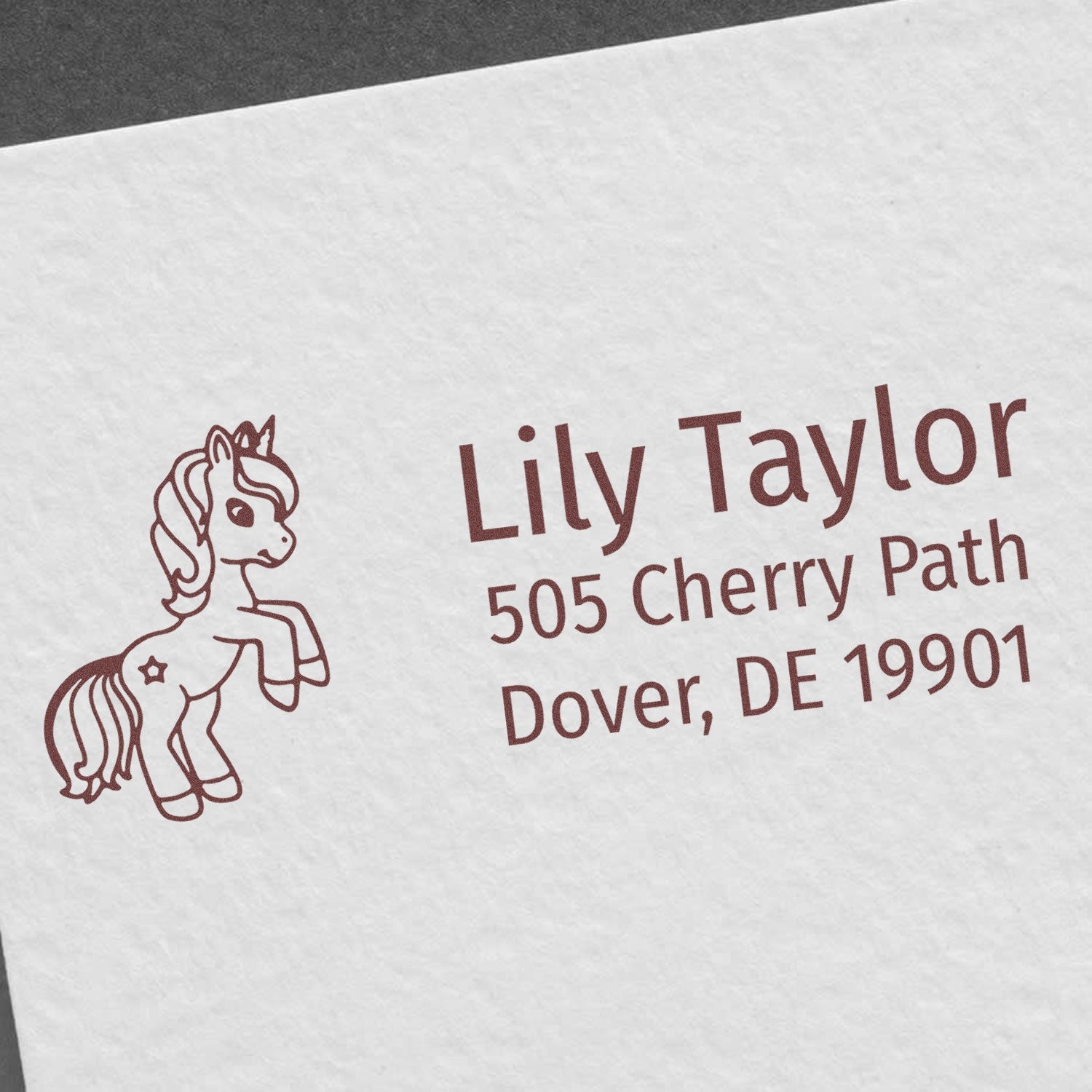 Custom rubber return address stamp with pony icon for Lily Taylor, 505 Cherry Path, Dover, DE 19901.