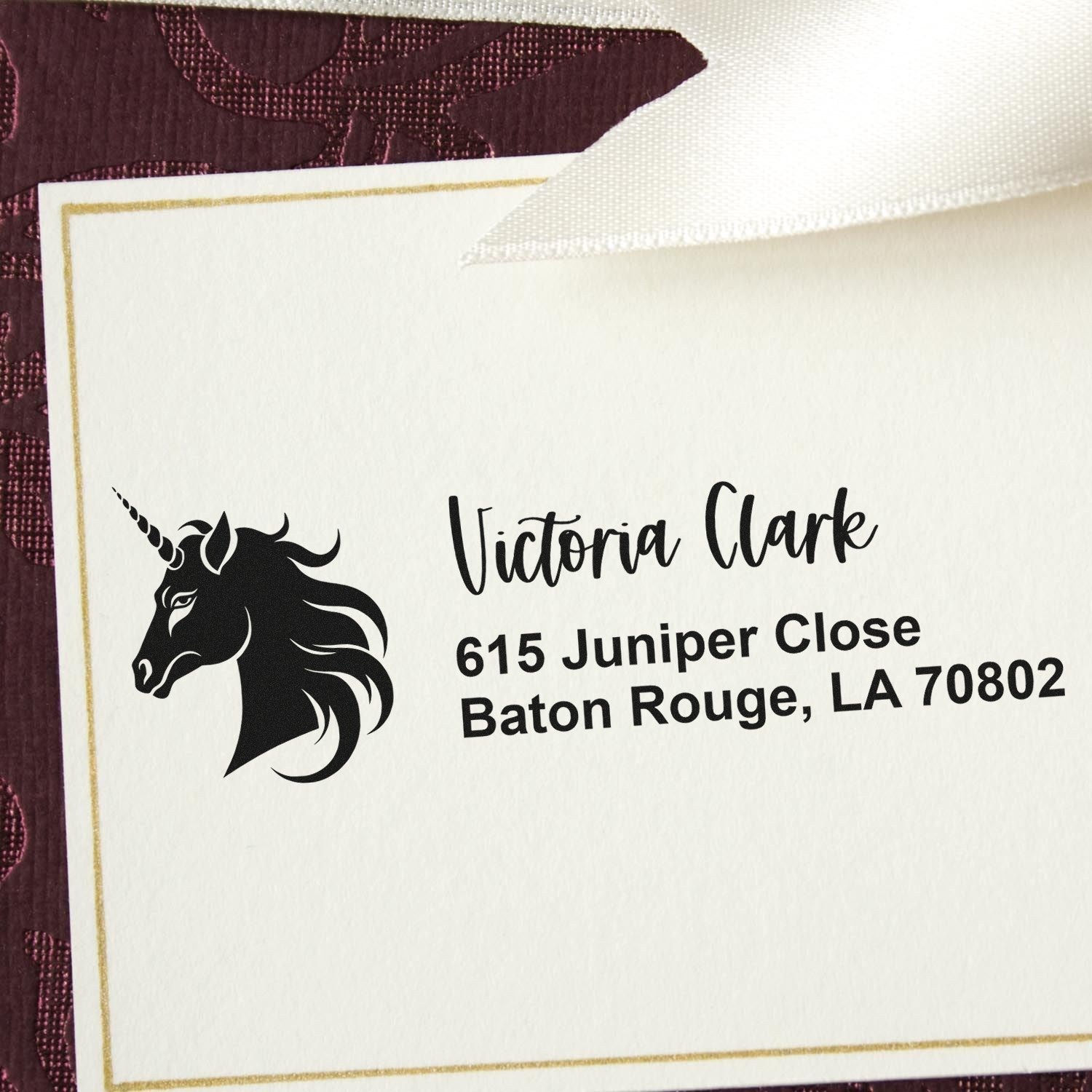 Custom rubber return address stamp with unicorn logo for Victoria Clarke, Baton Rouge, LA 70802.