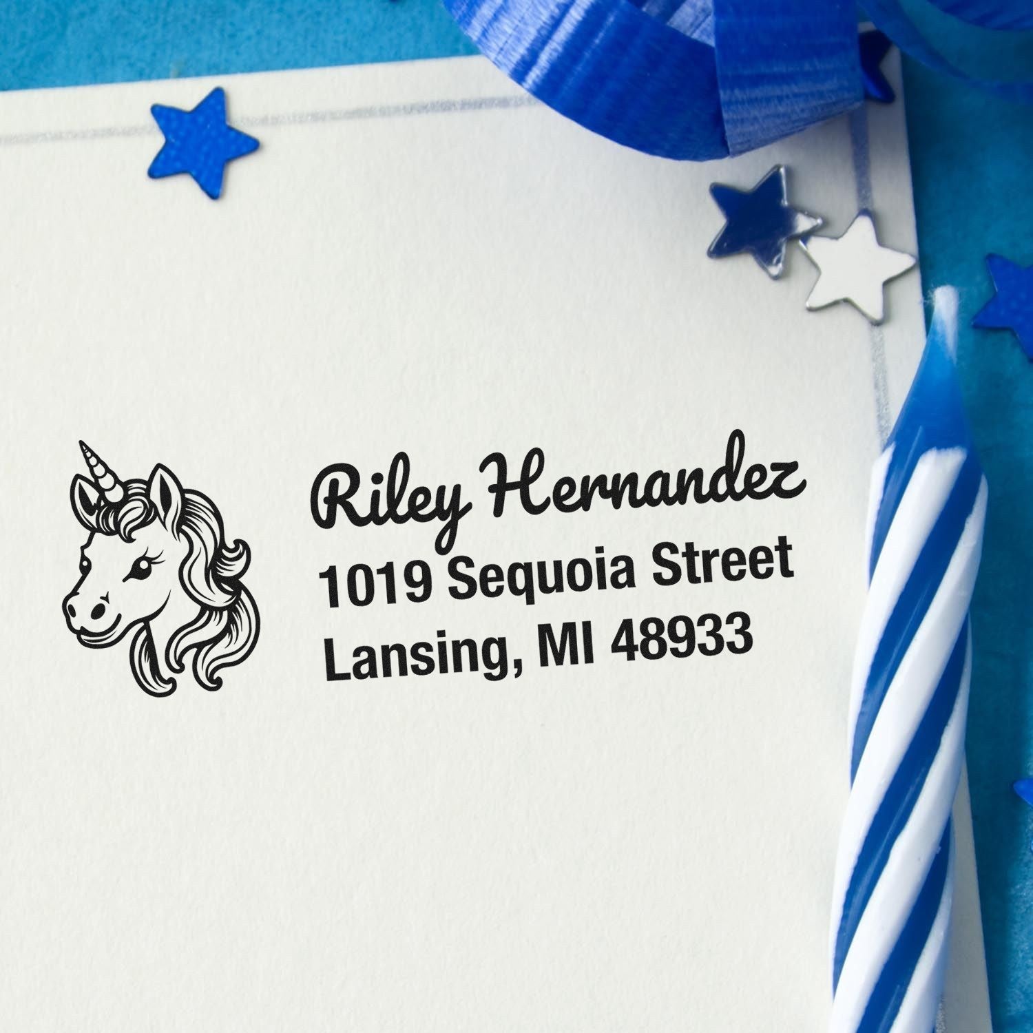 Custom unicorn address rubber stamp with name and mailing address on a white envelope for personalized stationery.