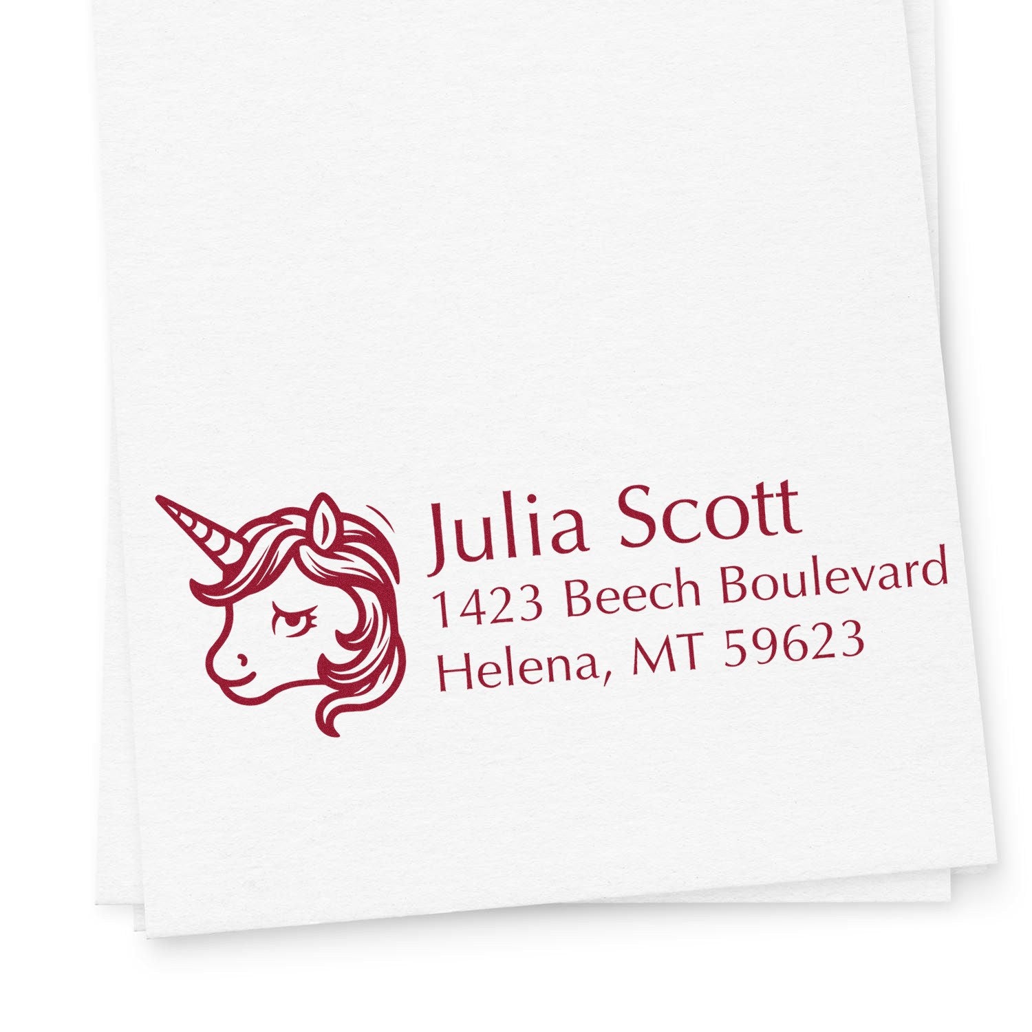 Custom unicorn return address rubber stamp with name and mailing address on white paper.
