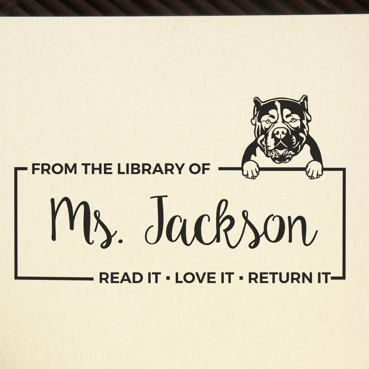 Custom library book rubber stamp with pit bull design and From the Library of Ms. Jackson return-it message.