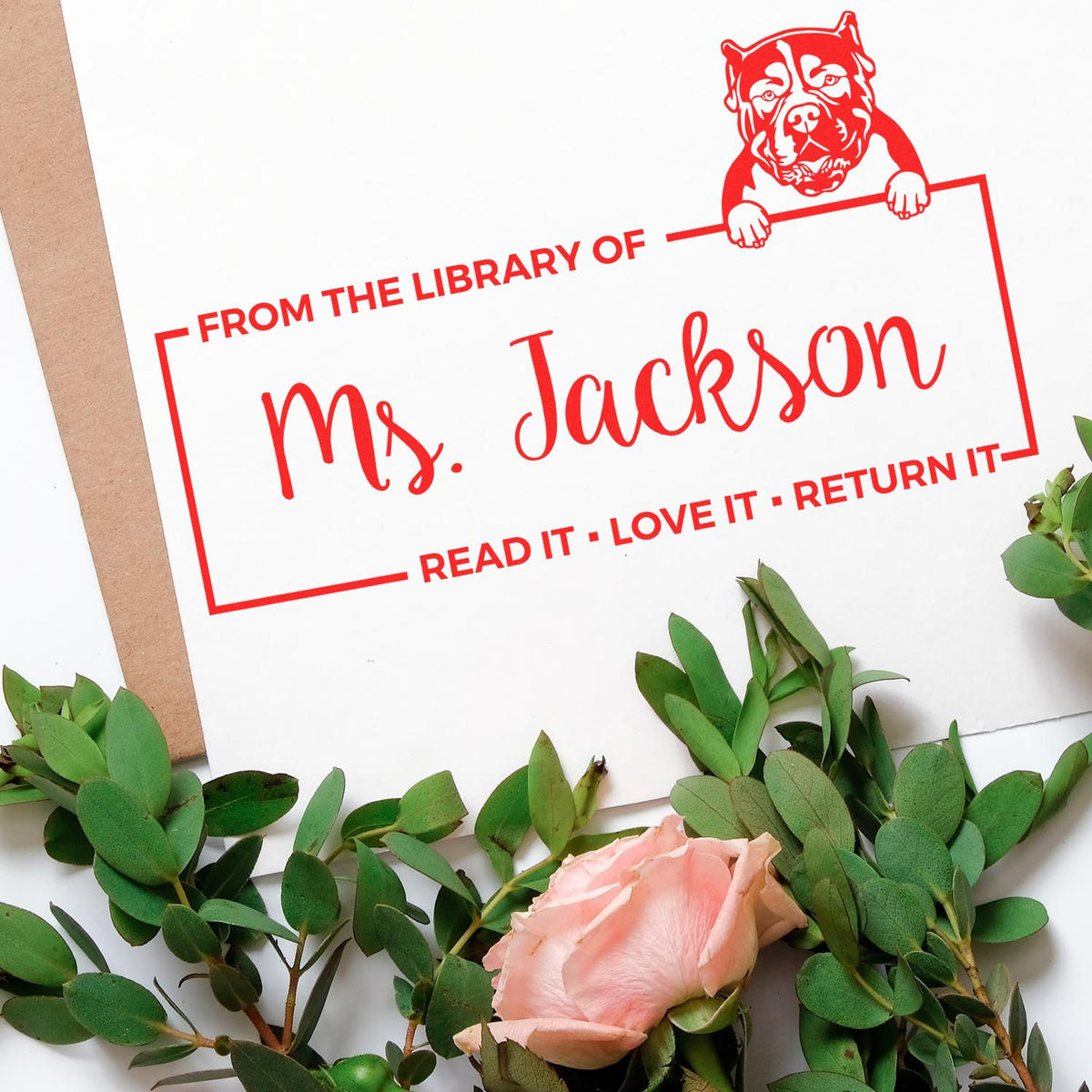 Personalized library book rubber stamp for Ms. Jackson with dog graphic and Read it, love it, return it message.