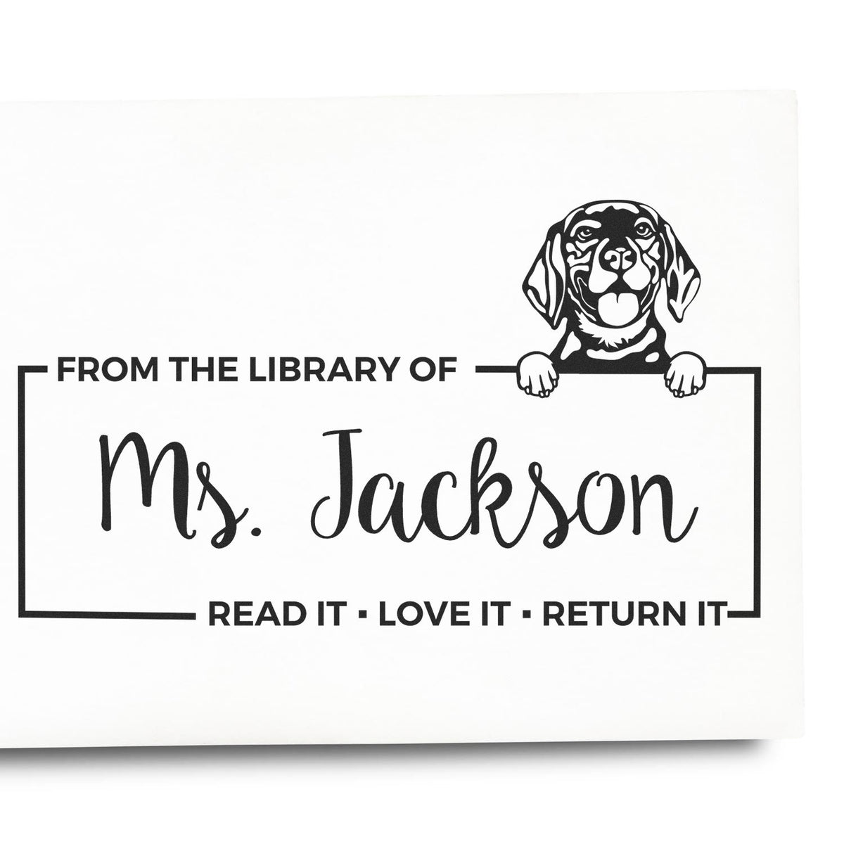Personalized library rubber stamp with dog illustration and Ms. Jackson name, featuring Read it, Love it, Return it.