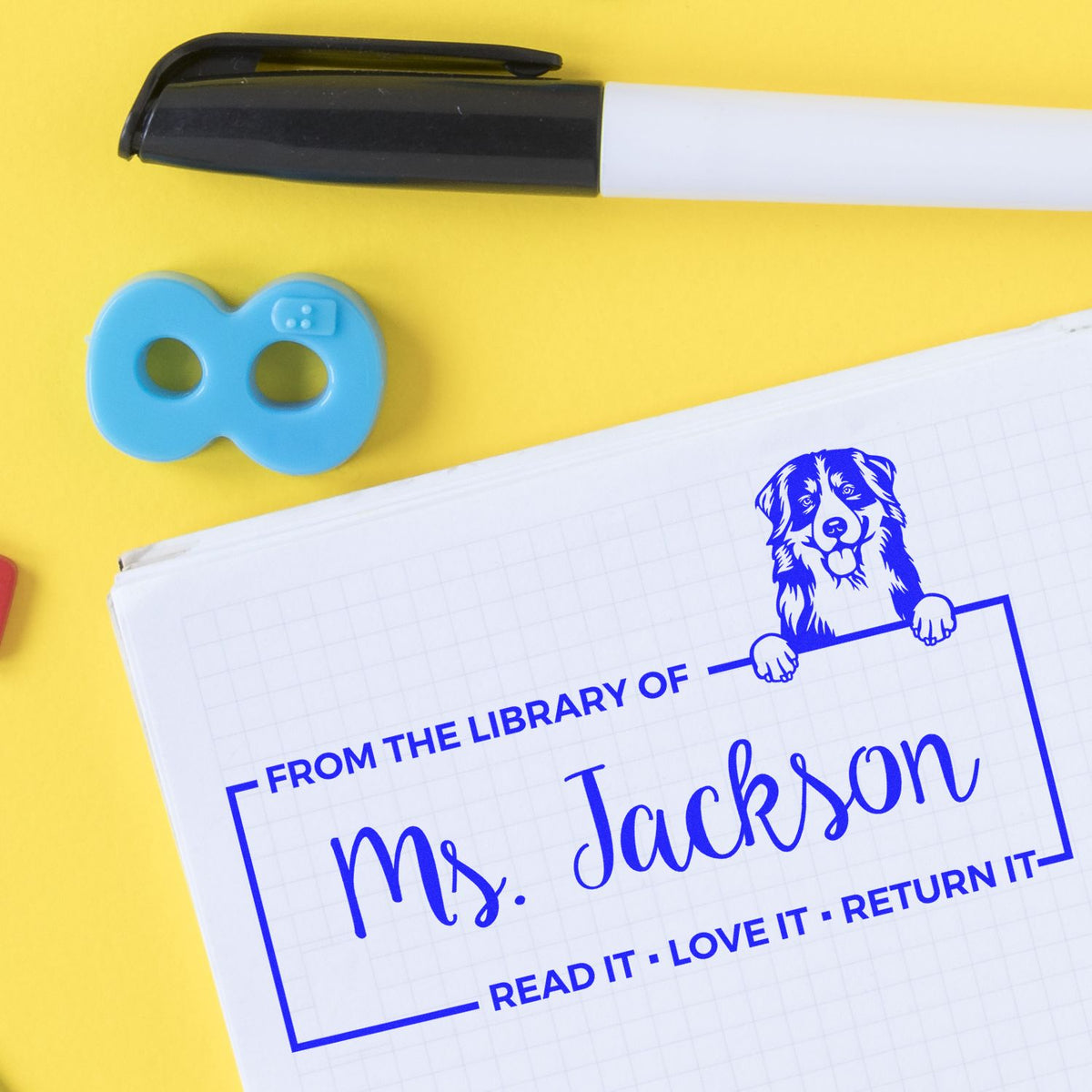Custom rubber library stamp with dog illustration and From the Library Of name for personalized books.
