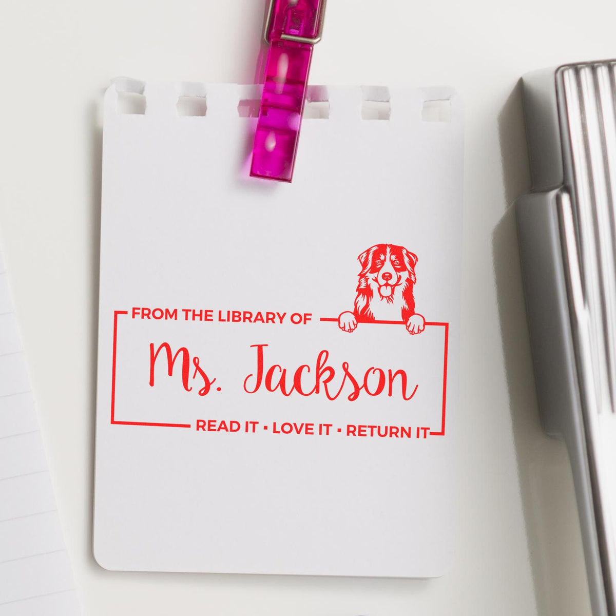 Personalized library rubber stamp for Ms. Jackson with dog design and Read it, love it, return it book ownership mark.