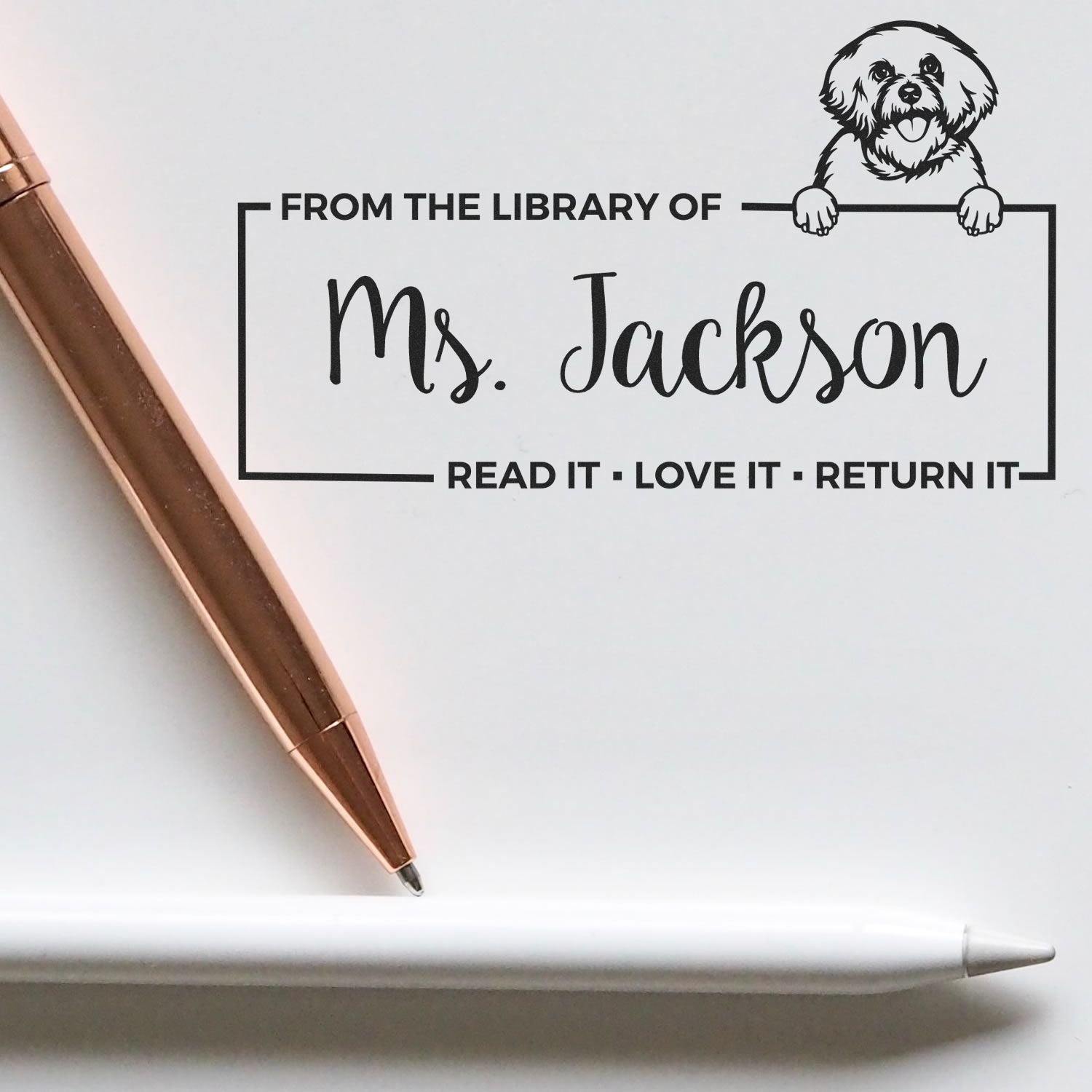 Personalized library rubber stamp for Ms. Jackson with dog art and Read it, Love it, Return it bookplate text.