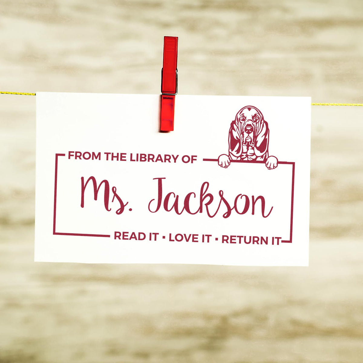 Custom library rubber stamp for Ms. Jackson with dog illustration and Read It, Love It, Return It bookplate design.