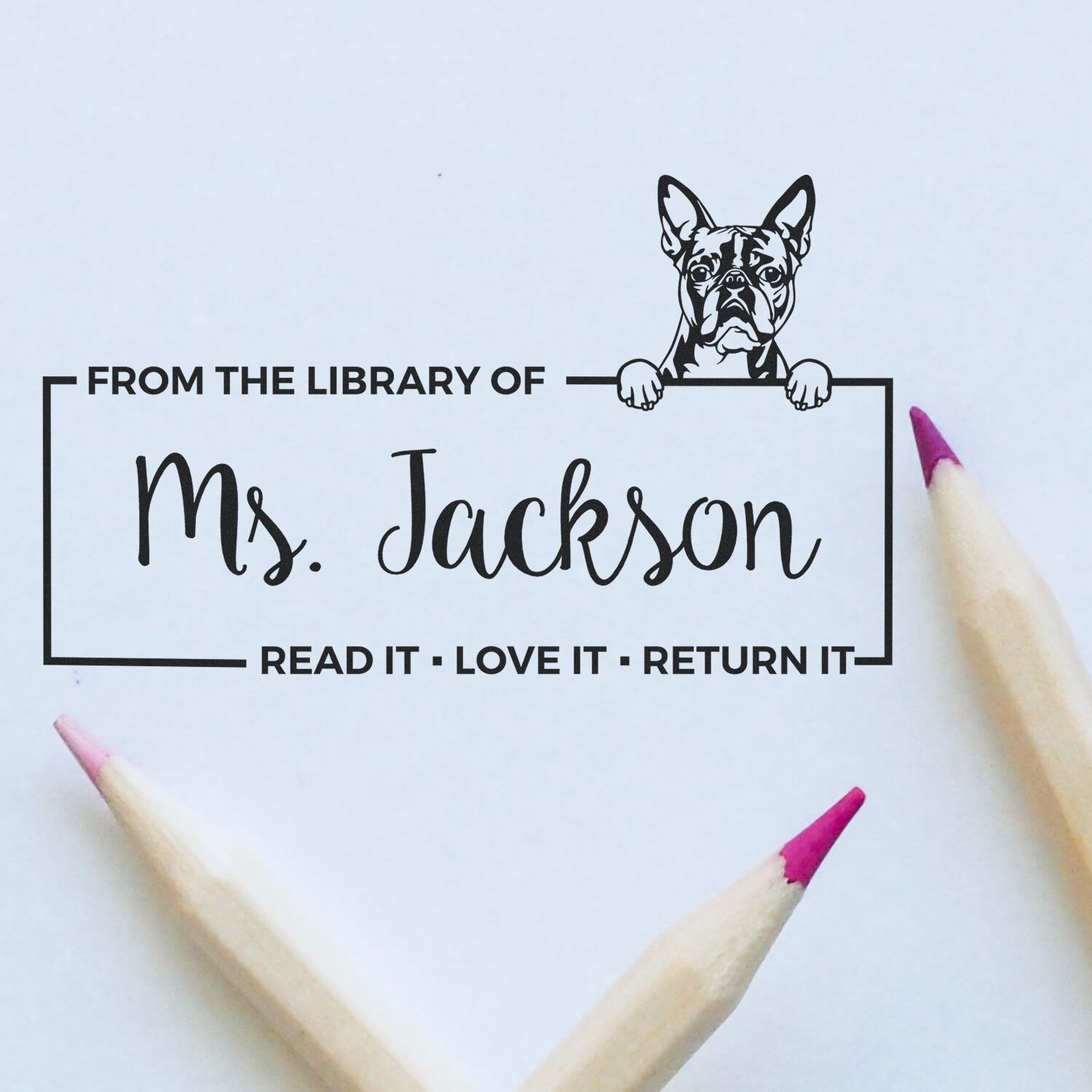 Custom rubber library stamp featuring a French bulldog and the text From the Library of Ms. Jackson for book lending.