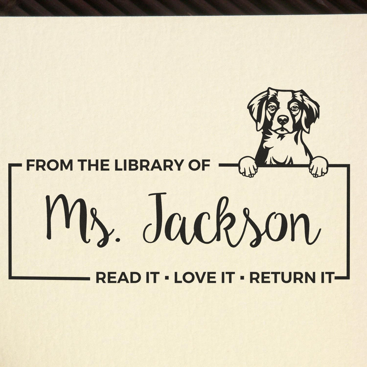 Personalized rubber stamp for books with dog illustration and From the Library of Ms. Jackson read-it, love-it, return-it text.