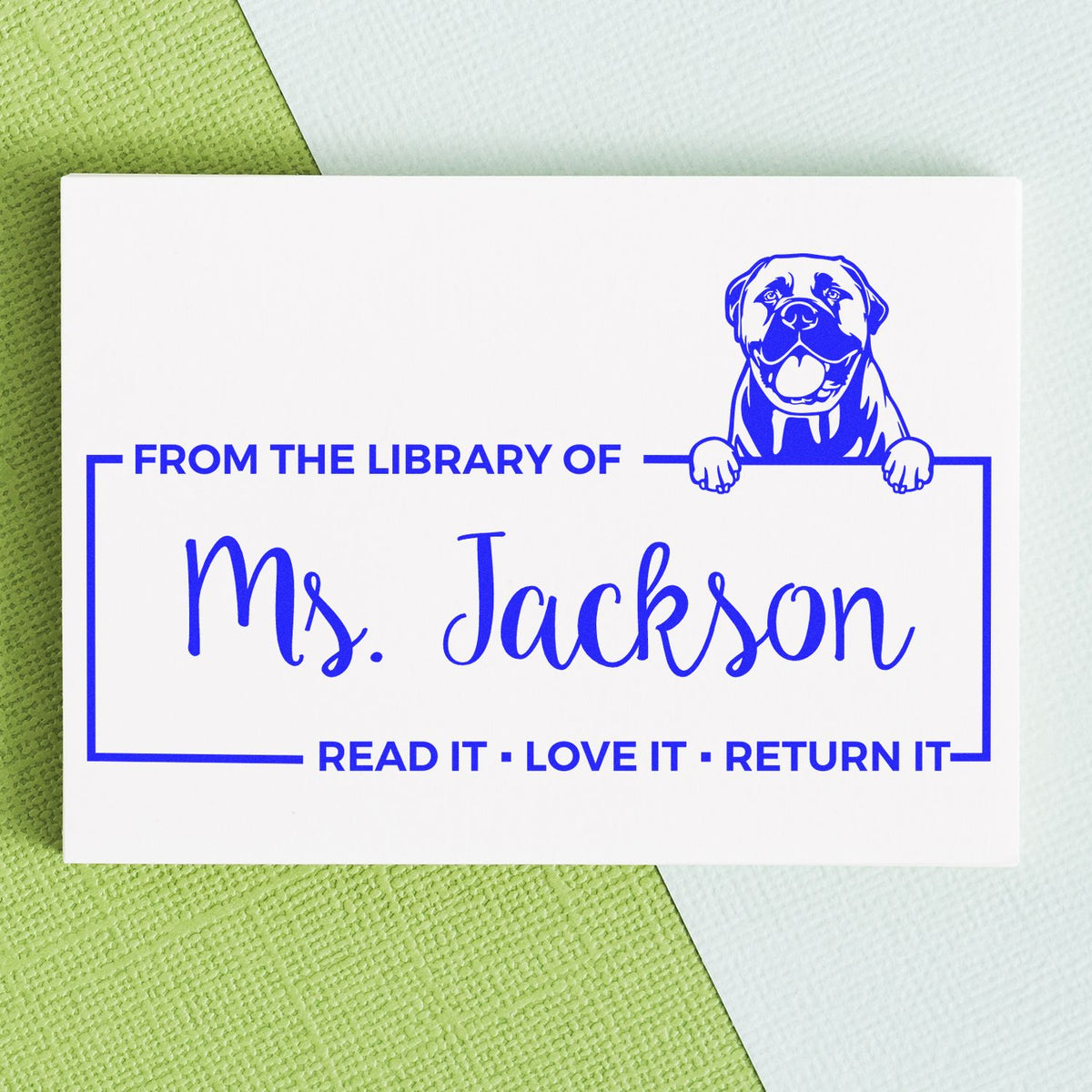 Custom library rubber stamp for Ms. Jackson with dog icon and Read It, Love It, Return It message for book returns.