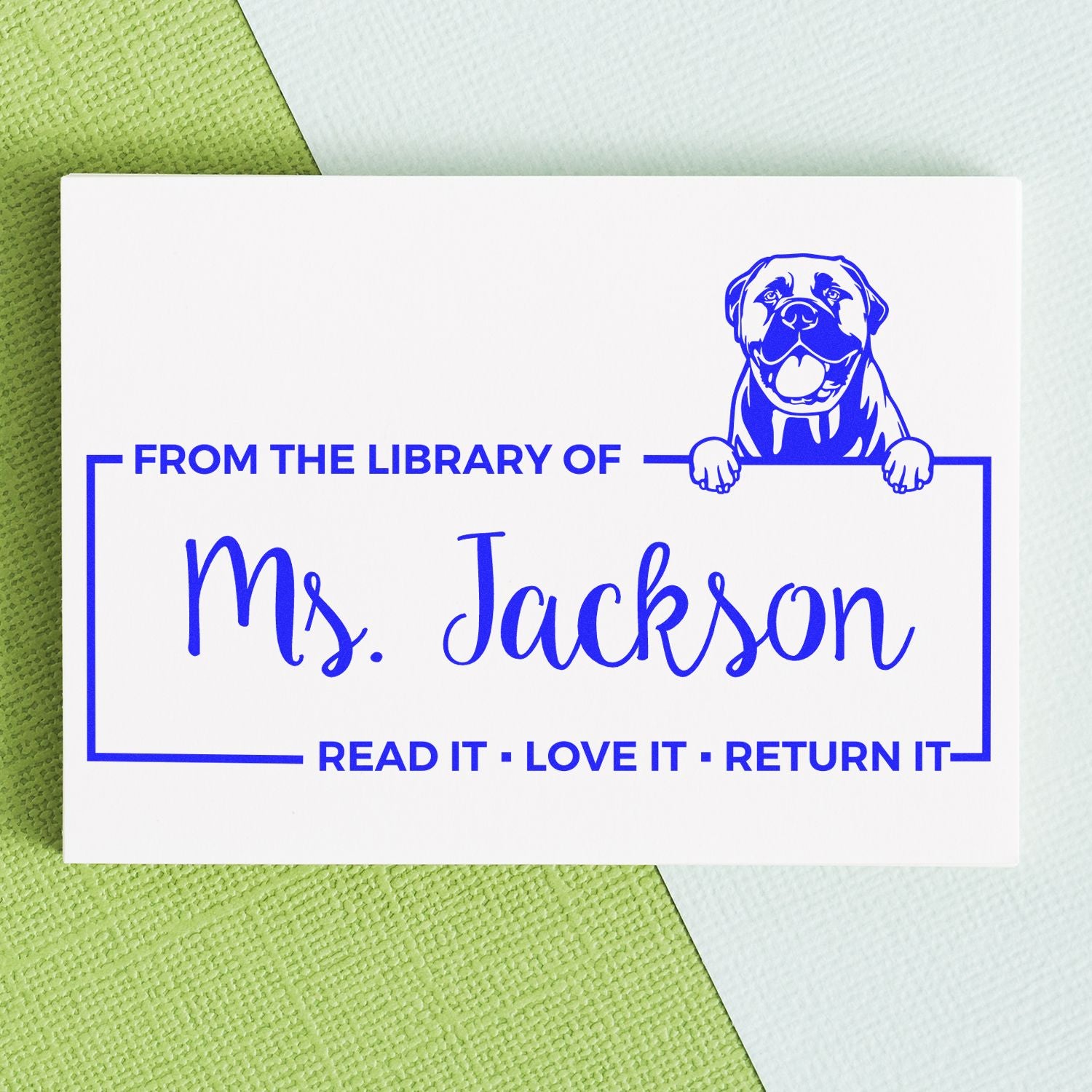 Custom rubber library book stamp for Ms. Jackson with dog design and Read It, Love It, Return It bookplate text.