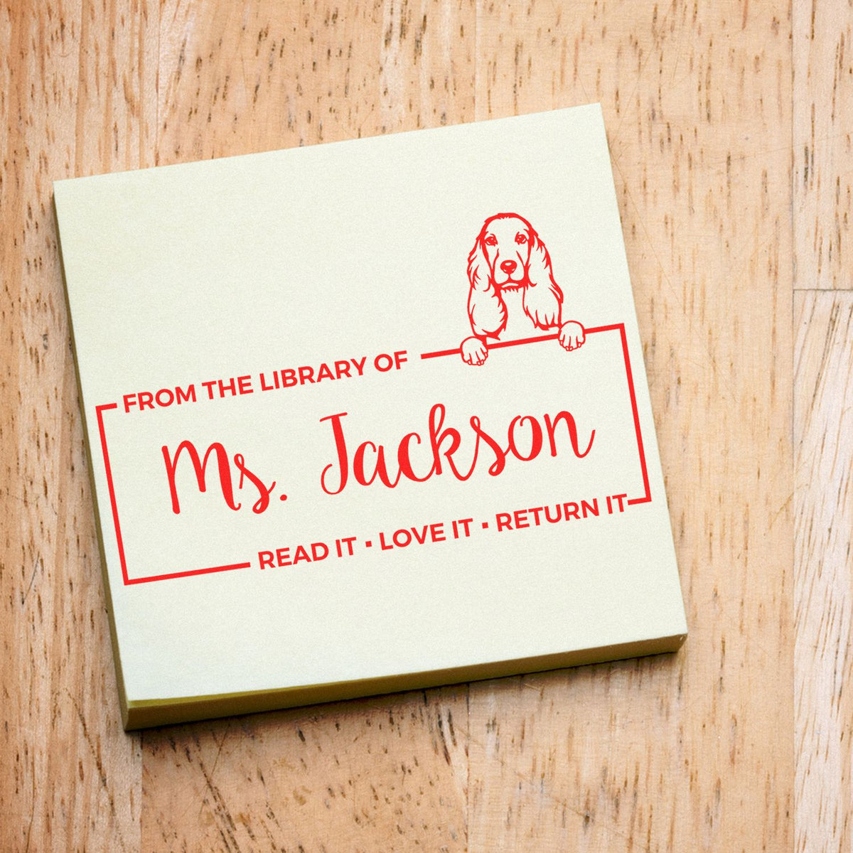 Personalized rubber library stamp for Ms. Jackson with dog illustration and Read it, Love it, Return it book ownership text.