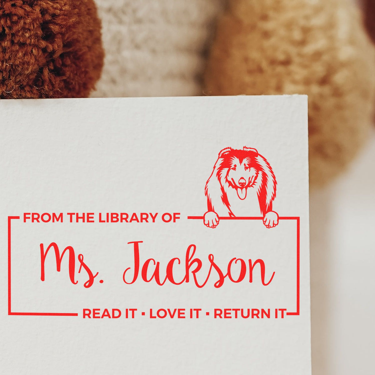 Personalized library rubber stamp for Ms. Jackson with dog design and Read it, Love it, Return it bookplate text.