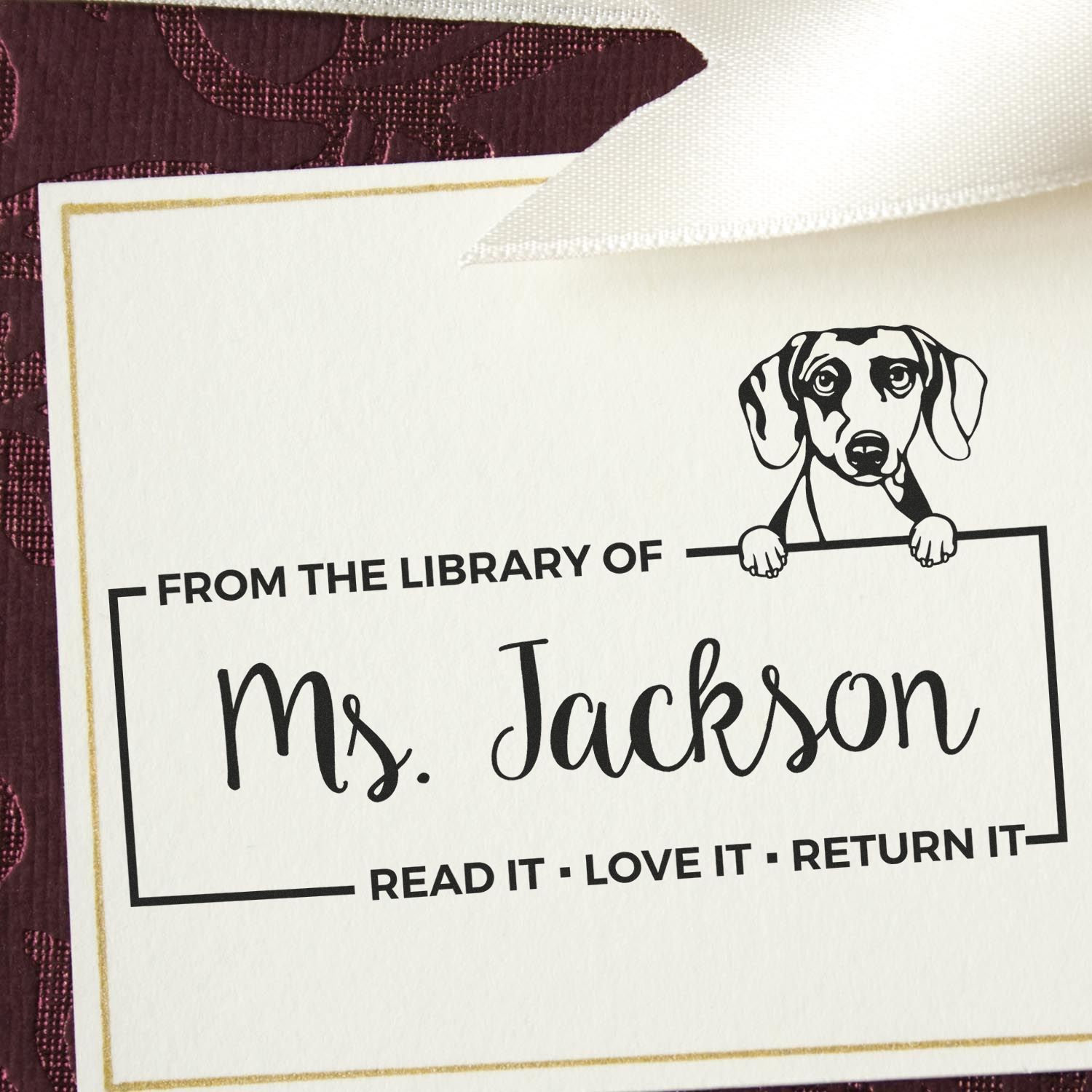 Custom dog-themed rubber stamp for personal books, reading From the Library of Ms. Jackson with return reminder.