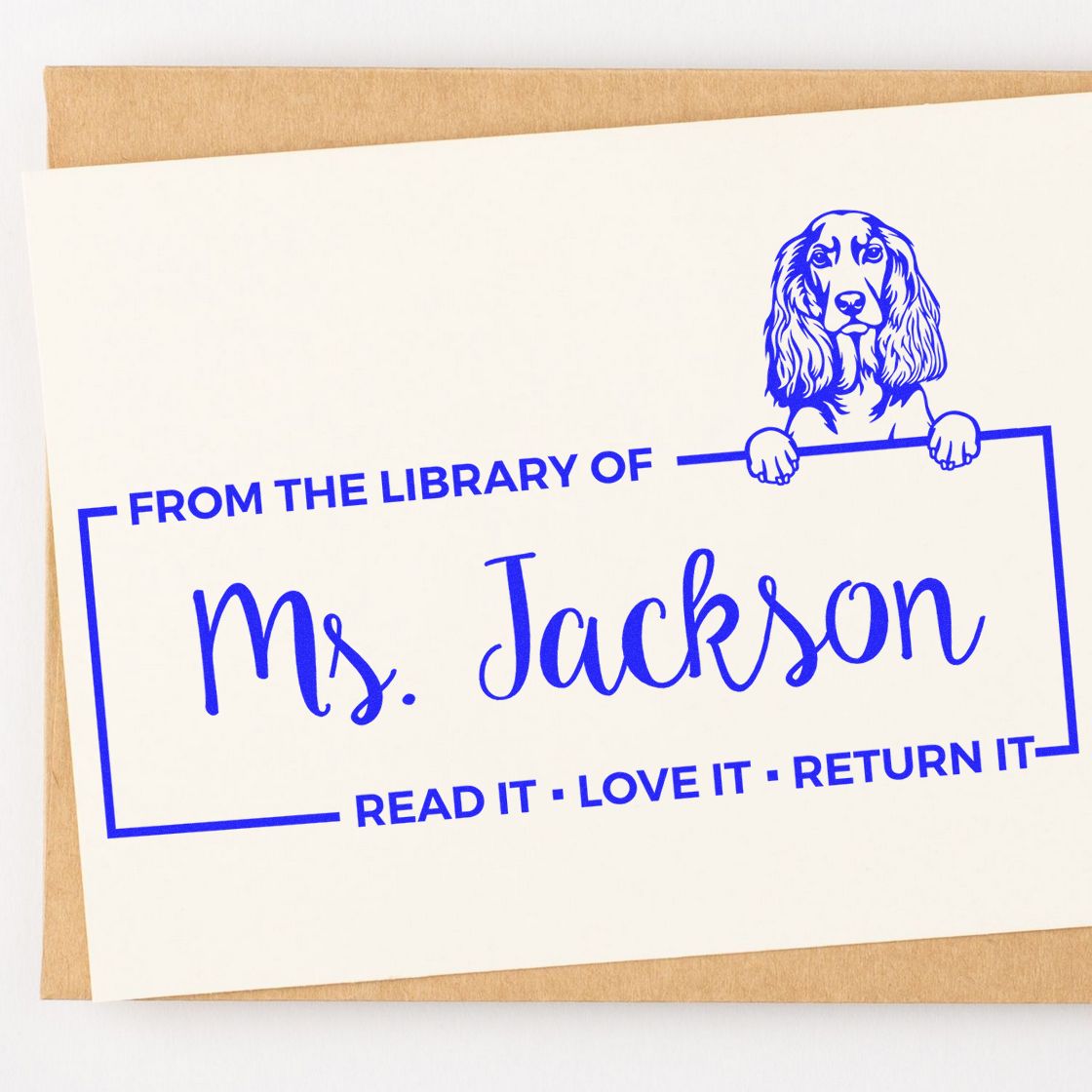 Custom library rubber stamp for Ms. Jackson with dog illustration and Read it, love it, return it bookplate design.