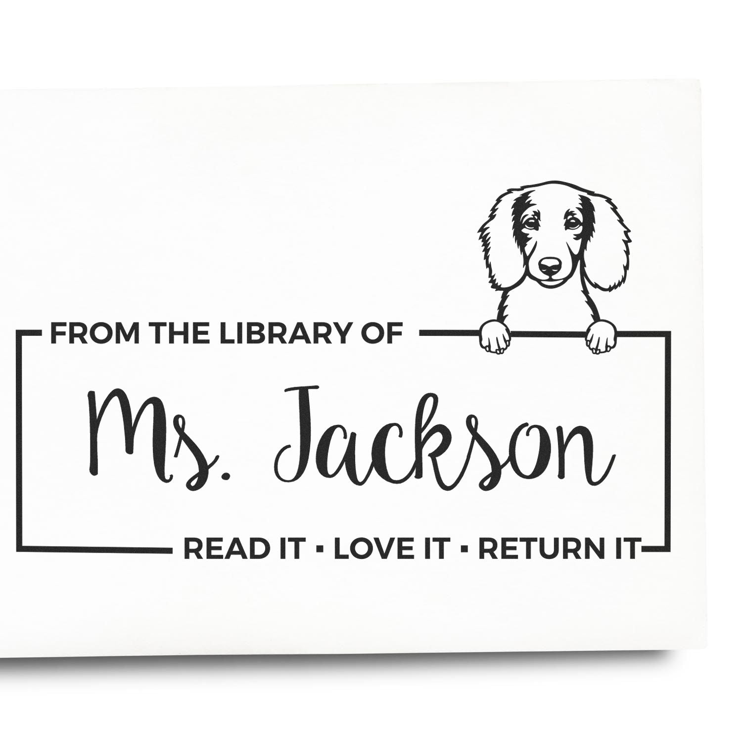 Custom library rubber stamp for Ms. Jackson with dog illustration and Read it, love it, return it book label.