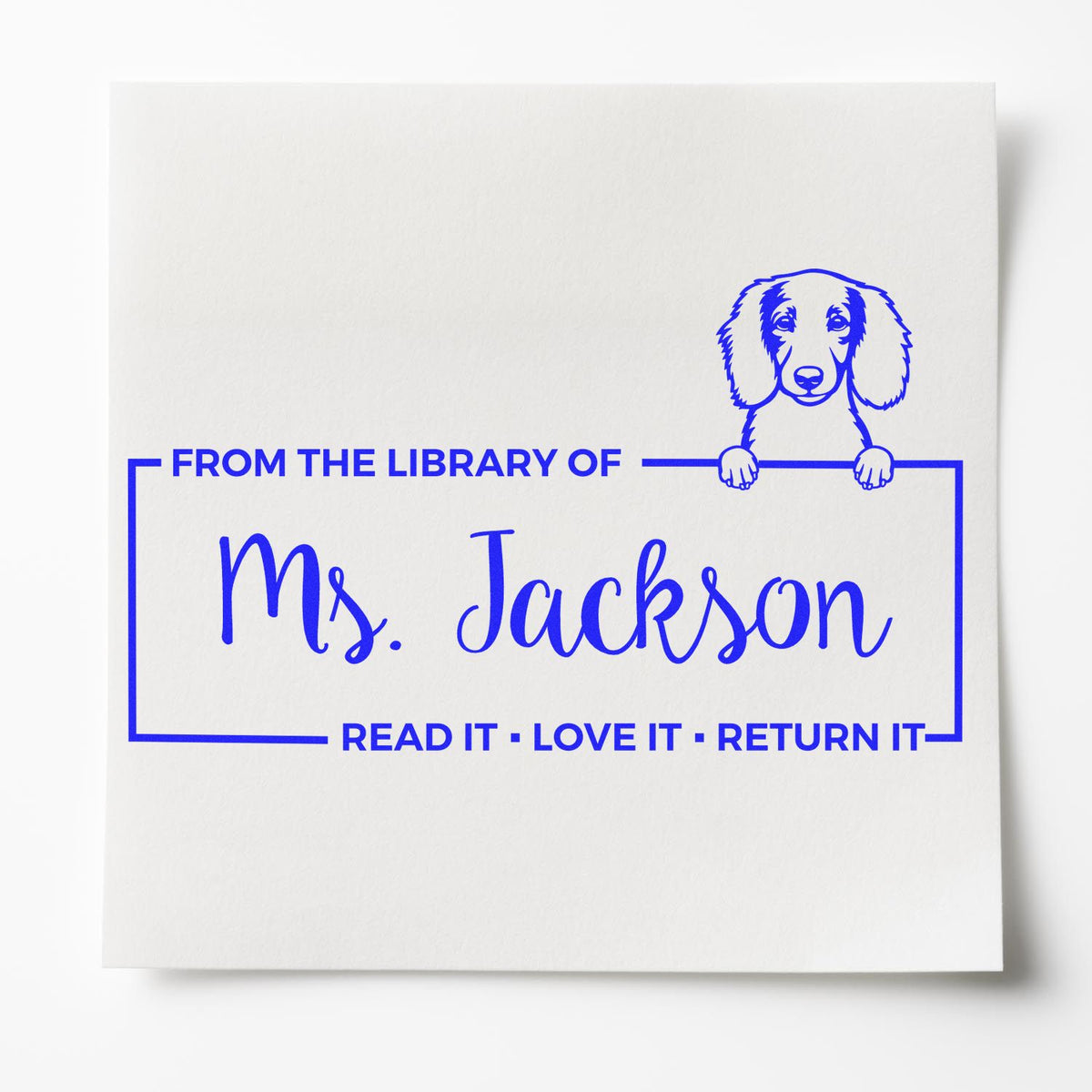 Personalized library rubber stamp for Ms. Jackson, featuring a dog and Read it, Love it, Return it bookplate design.