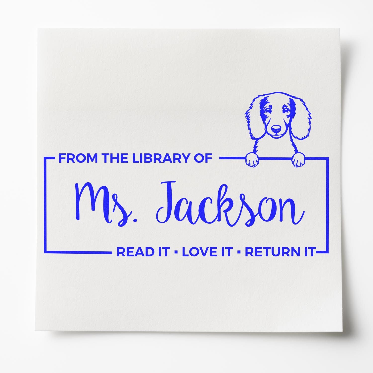 Personalized library book return rubber stamp for Ms. Jackson with dog illustration and Read it, love it, return it text.
