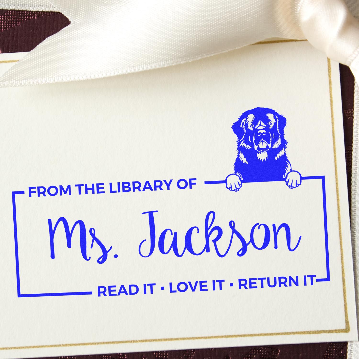Custom library rubber stamp for Ms. Jackson with dog graphic and Read it, love it, return it bookplate text.