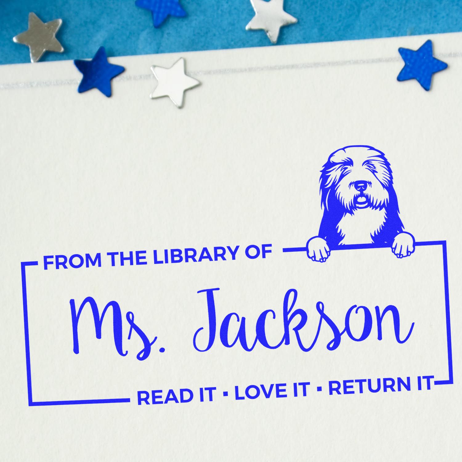 Custom rubber stamp for Ms. Jackson's library books, featuring dog art and Read it, Love it, Return it return message.