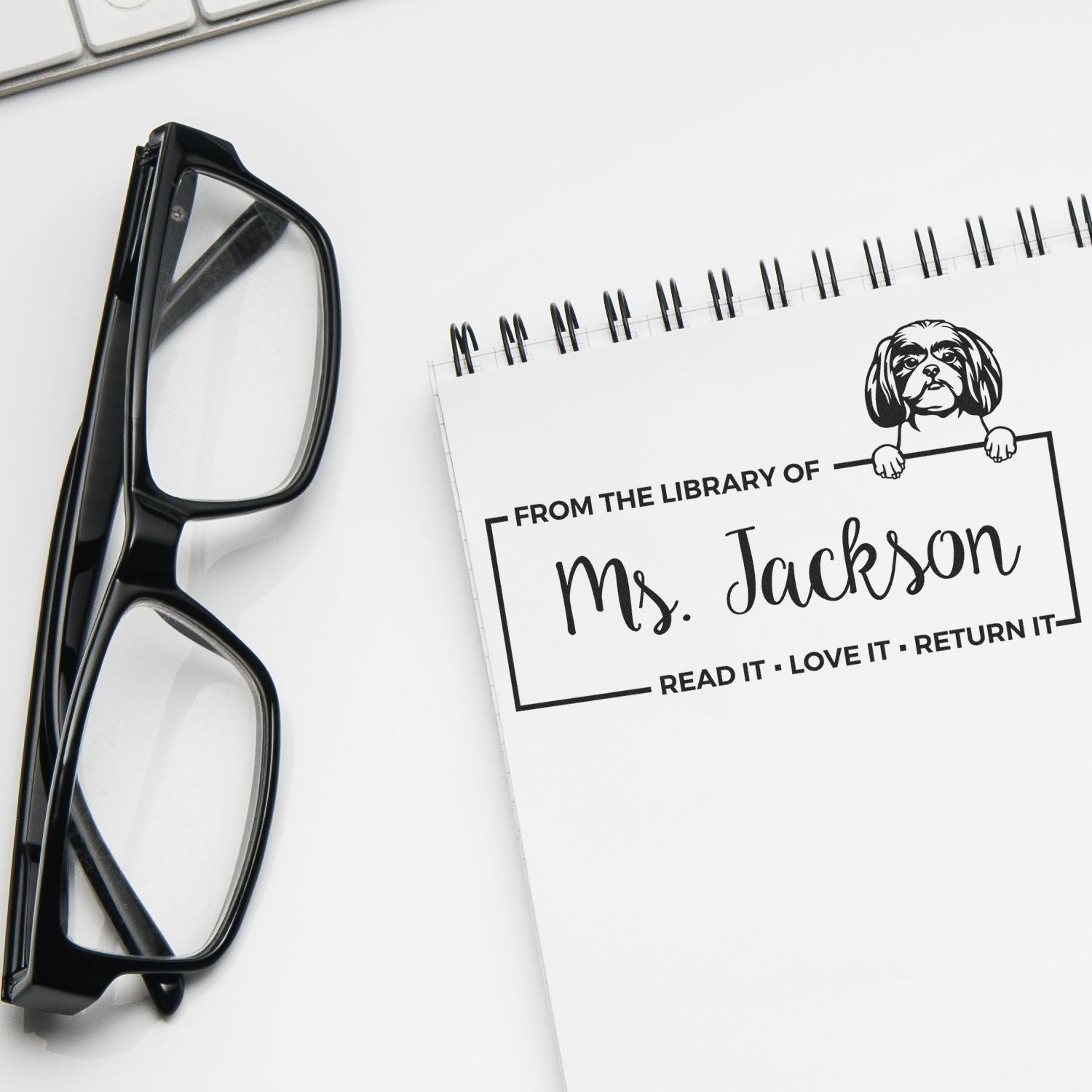 Custom library book return rubber stamp with dog design, reading From the Library of Ms. Jackson, for personalized books.