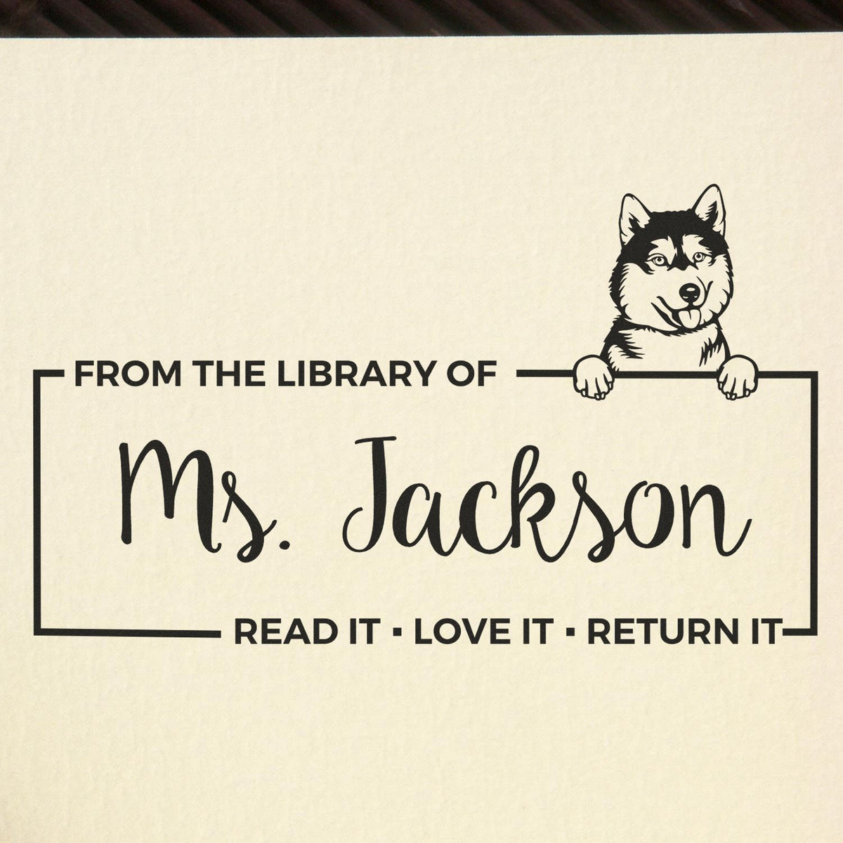 Personalized library bookplate rubber stamp for Ms. Jackson with husky design and Read It, Love It, Return It message.