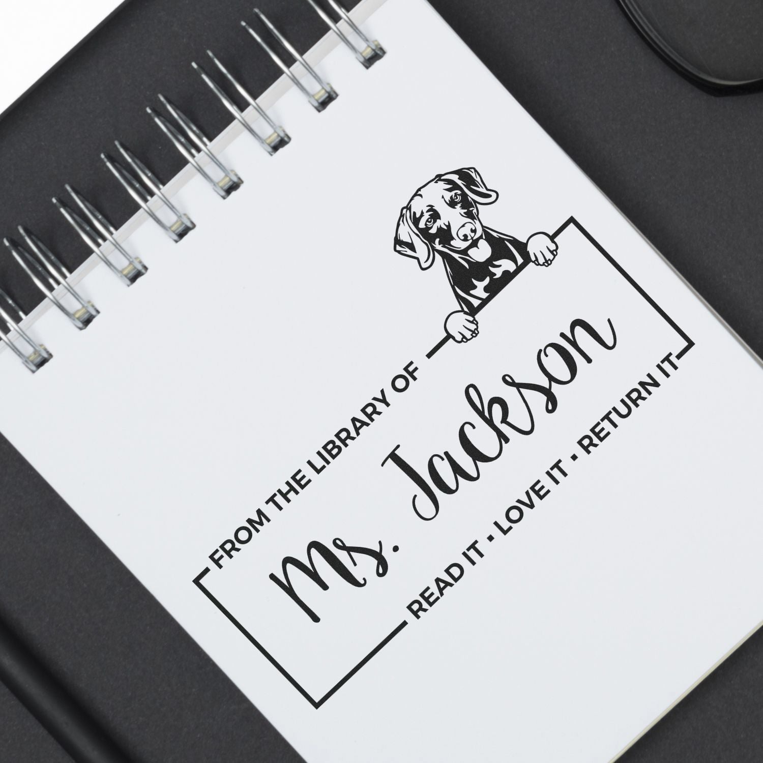 Custom rubber stamp for books with dog design, featuring From the Library of Mrs. Jackson and a return-it message.