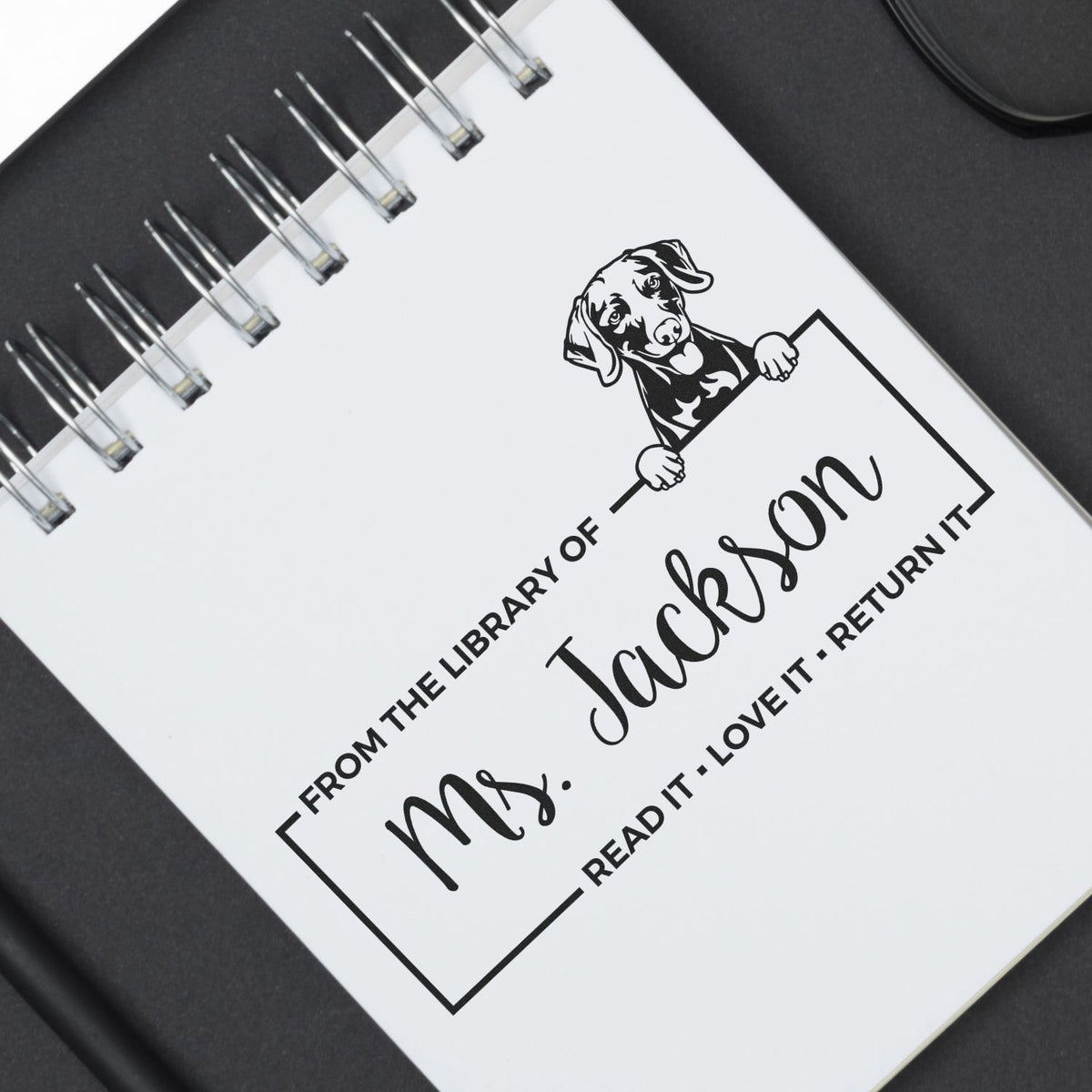 Custom rubber library stamp with dog design and personalized From the Library of Mrs. Jackson book return message.