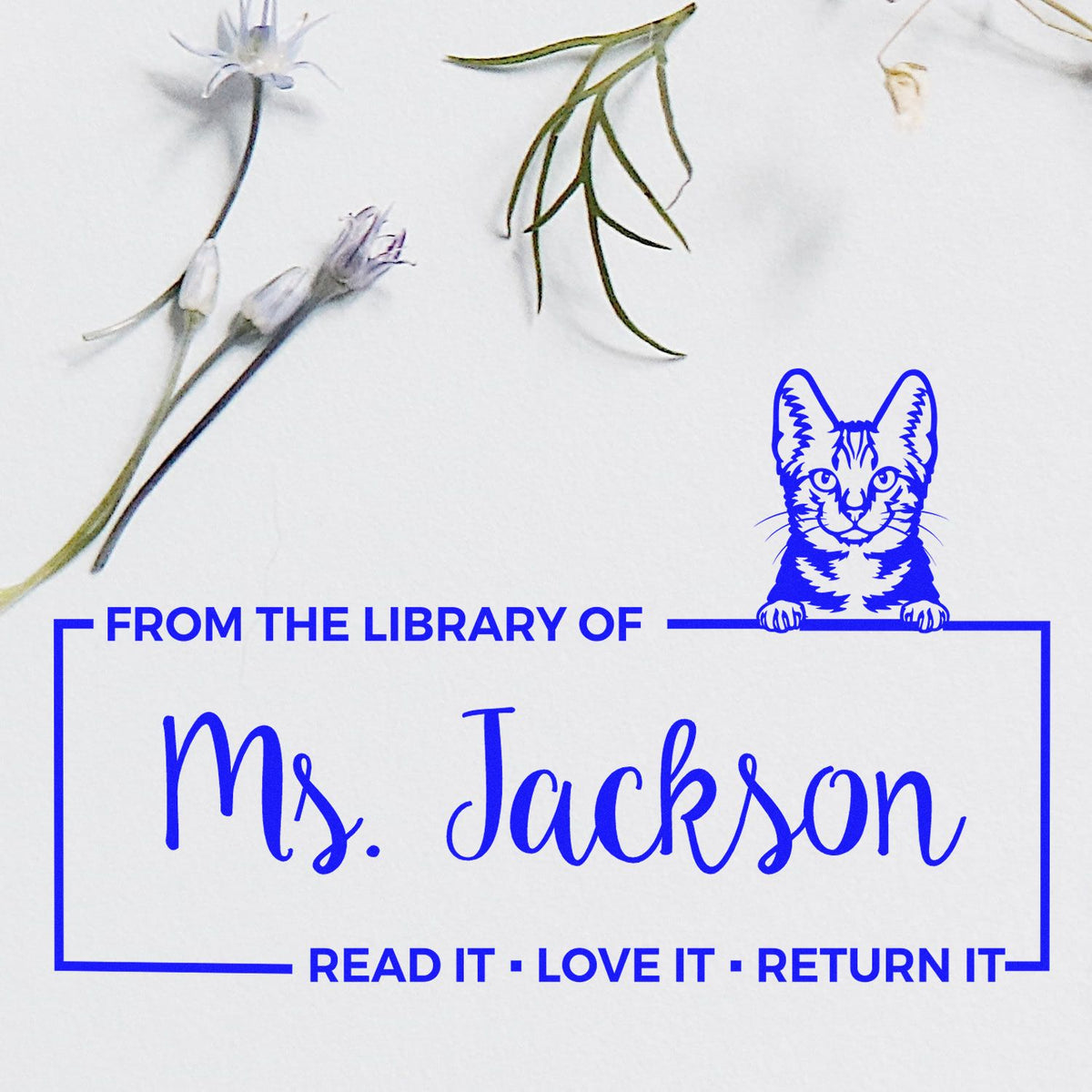 Personalized library rubber stamp with cat icon, reading From the Library of Ms. Jackson and Read It, Love It, Return It.