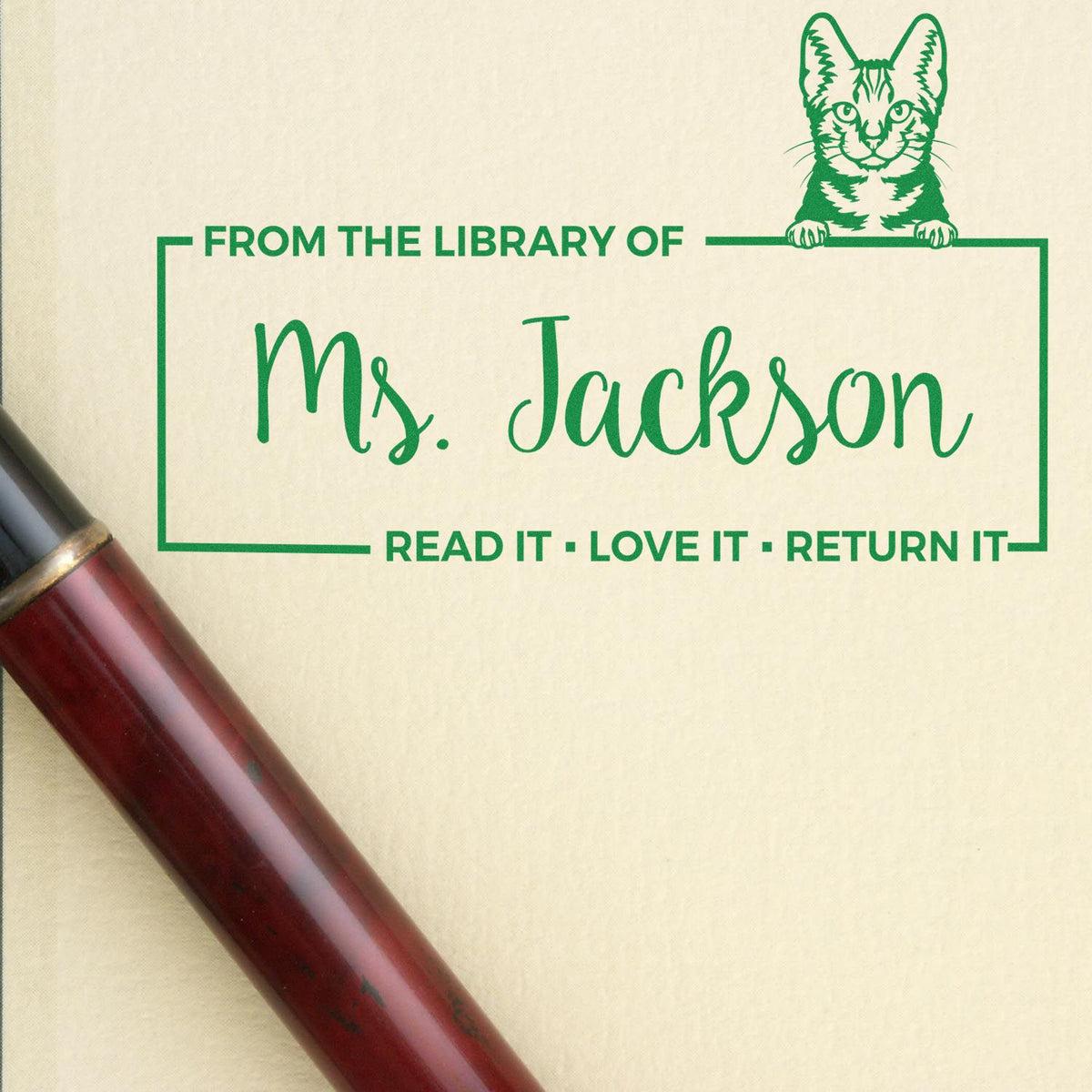 Personalized custom library rubber stamp with cat design for Ms. Jackson, featuring Read it, love it, return it.