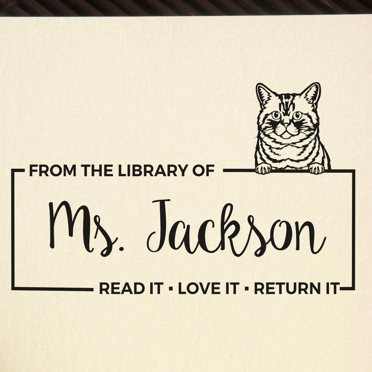 Personalized cat library rubber stamp reading From the Library of Ms. Jackson with Read it Love it Return it message.